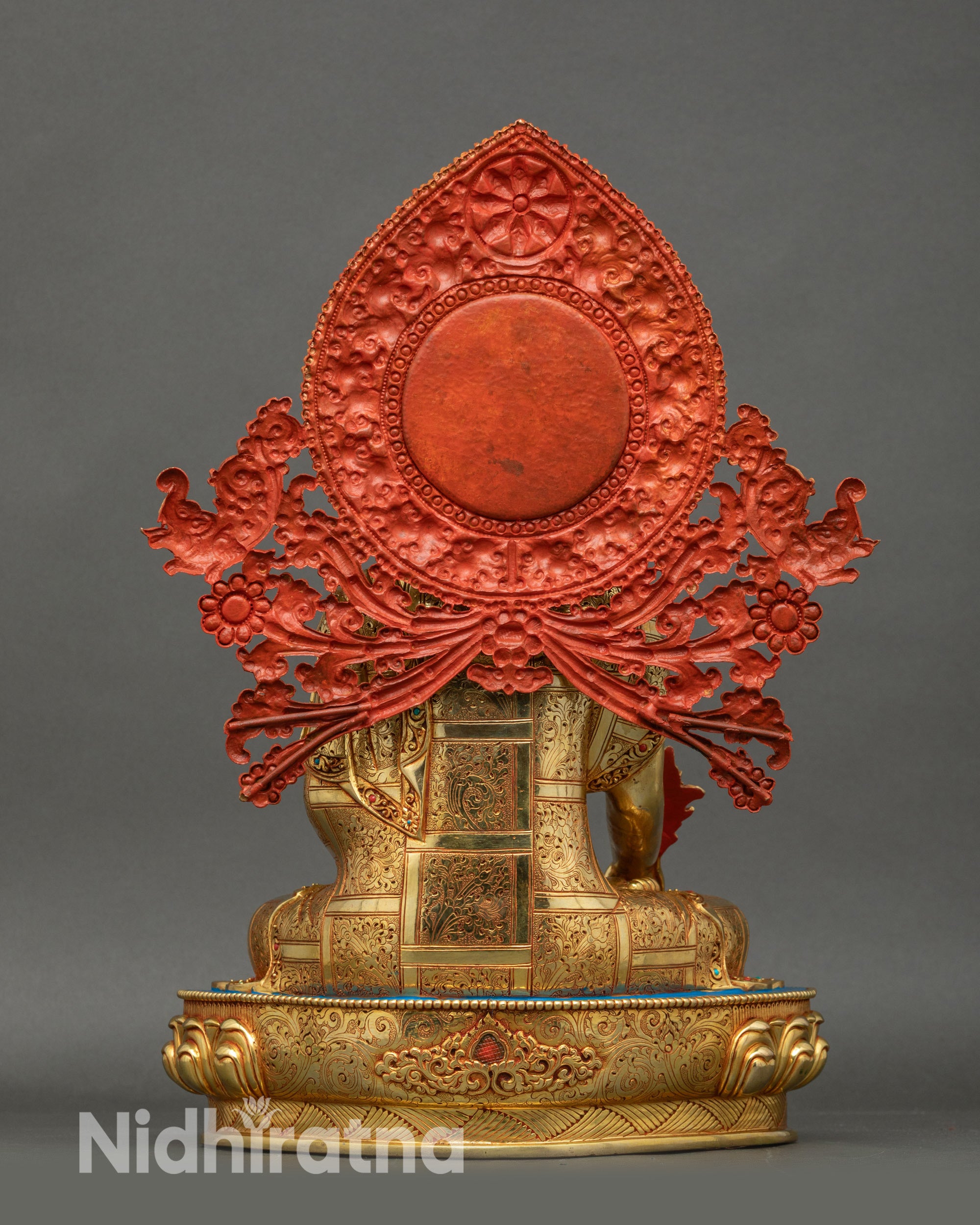 Back view of Medicine Buddha Statue, carved floral halo, copper and gold sculpture
