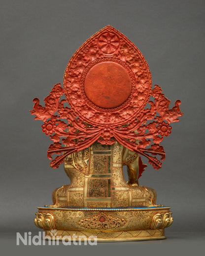 Back view of Medicine Buddha Statue, carved floral halo, copper and gold sculpture
