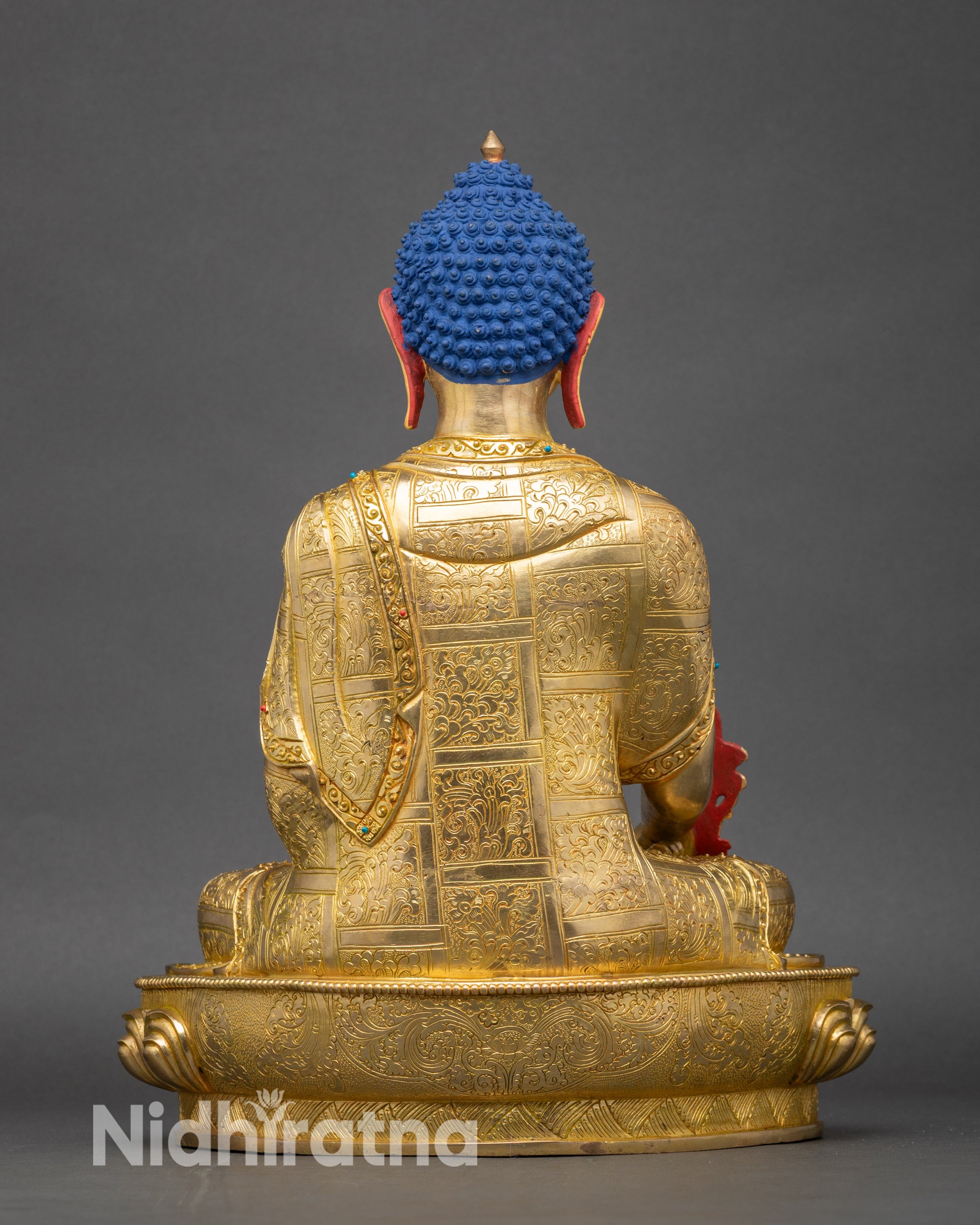 Back view of Medicine Buddha, showing lotus pedestal and ornate robe details