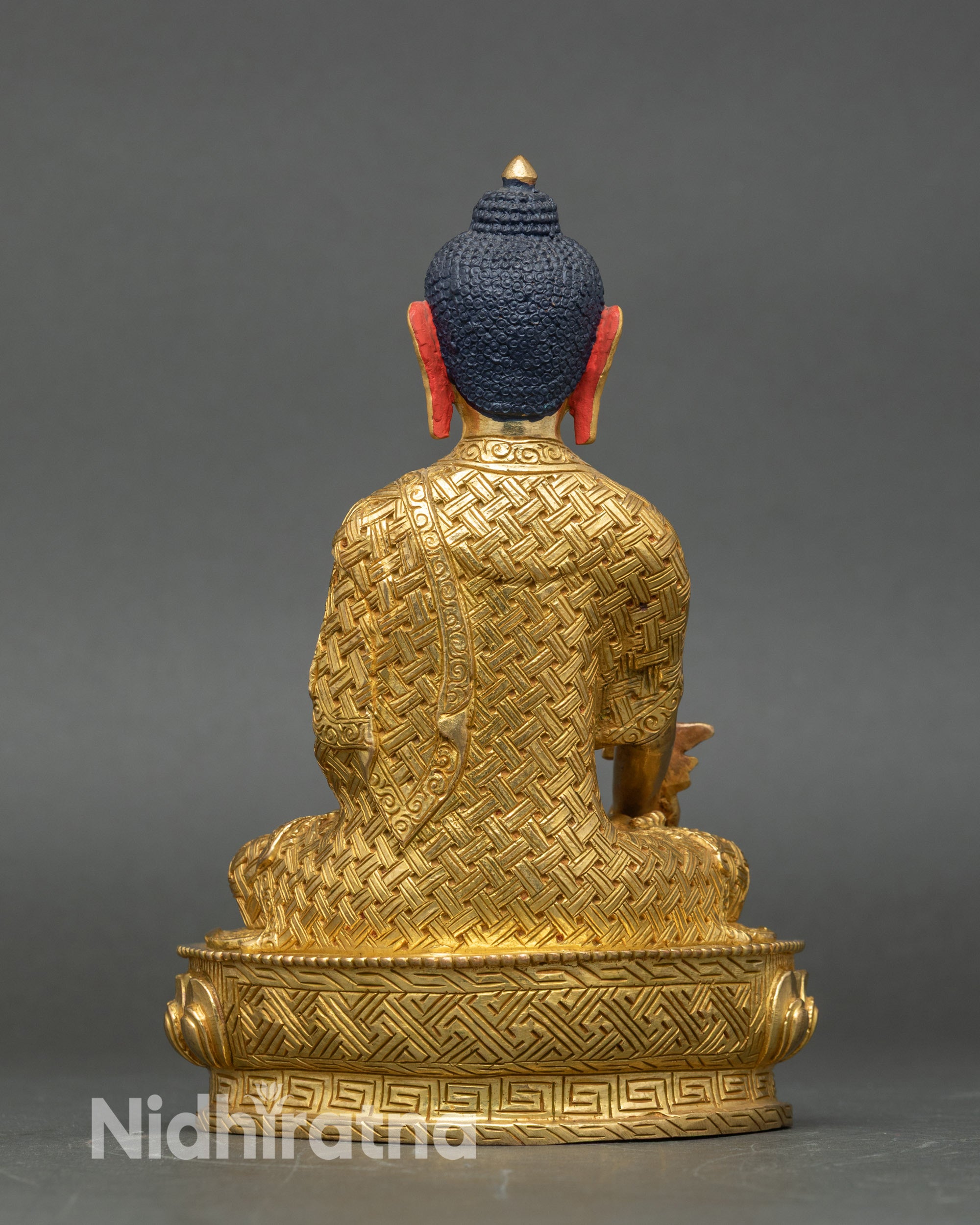 Back view of Medicine Buddha statue, detailed lotus seat and gold-gilded craftsmanship