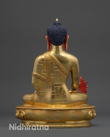 Back view of Medicine Buddha statue displaying carved robe and ritual form
