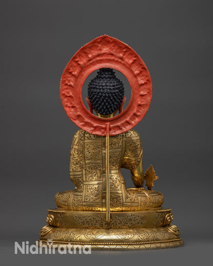 Back view of Medicine Buddha statue with detailed robe patterns and copper finish