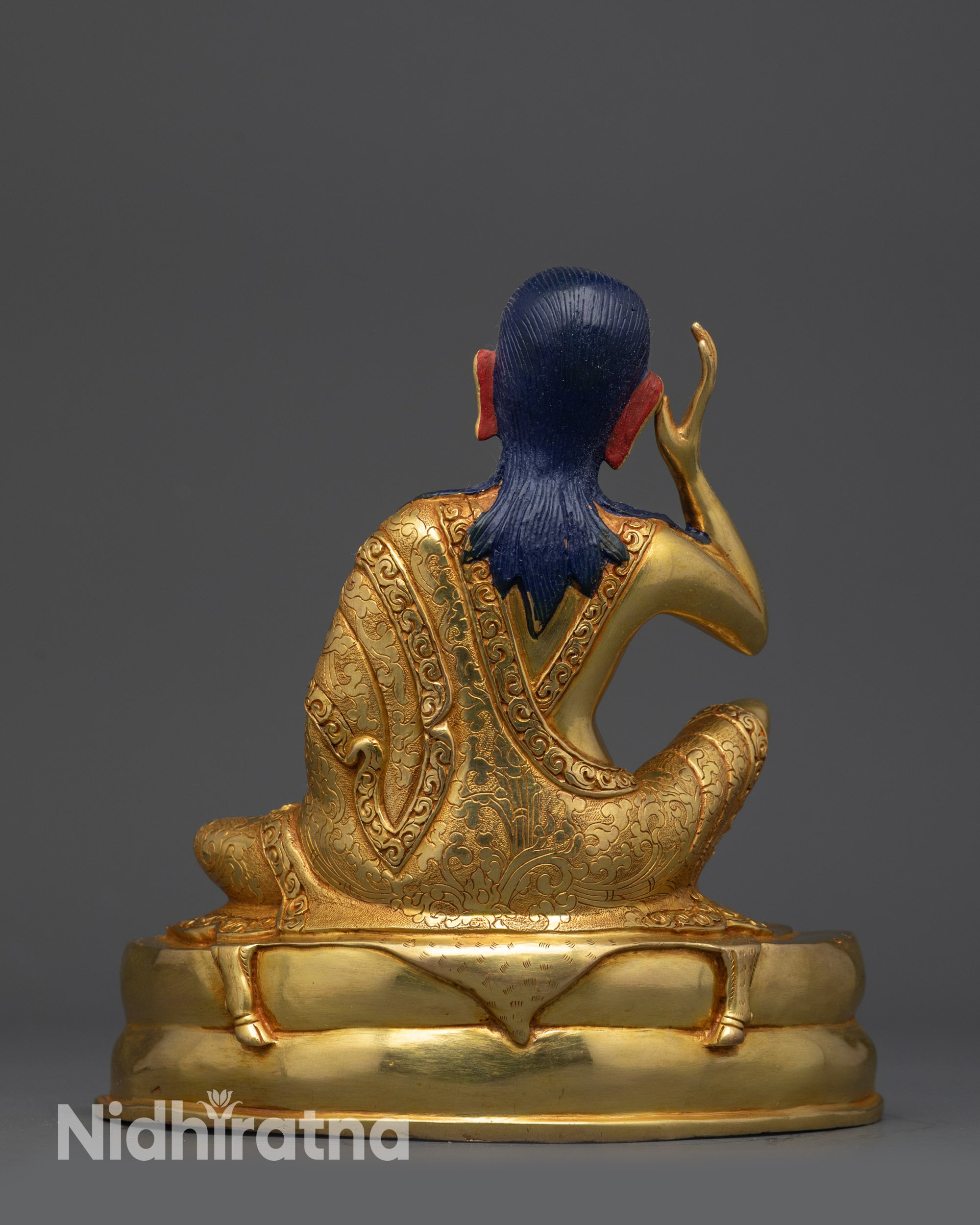 Back view of Milarepa statue showing detailed robe carvings and Newari craftsmanship