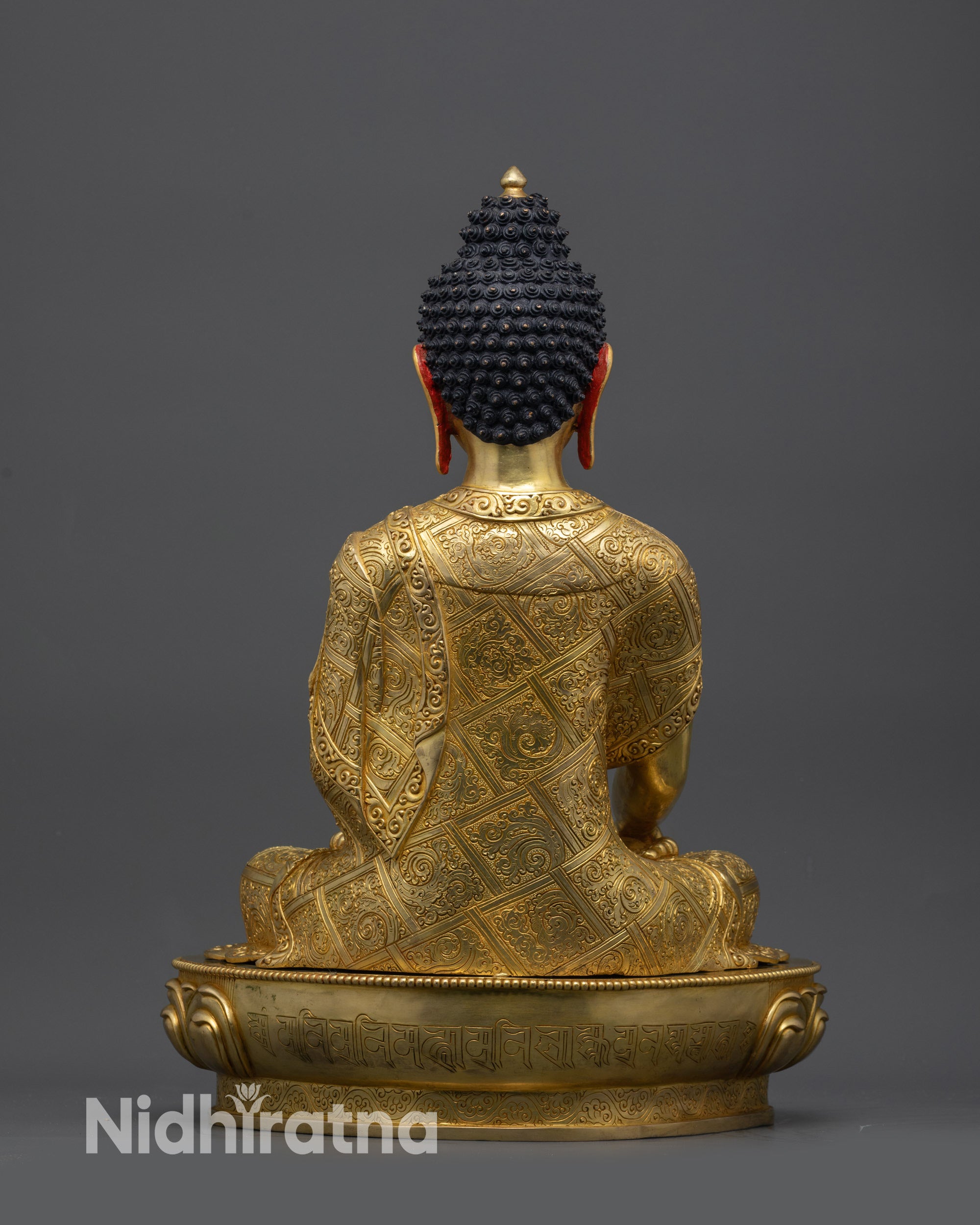 Back view of Mitrugpa Buddha statue showing sacred mantra Om Padma Akṣobhya Hum