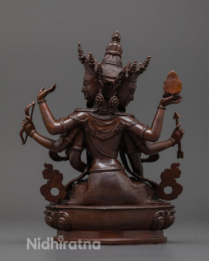 Back view of Namgyalma statue revealing oxidized copper texture and lotus base detail