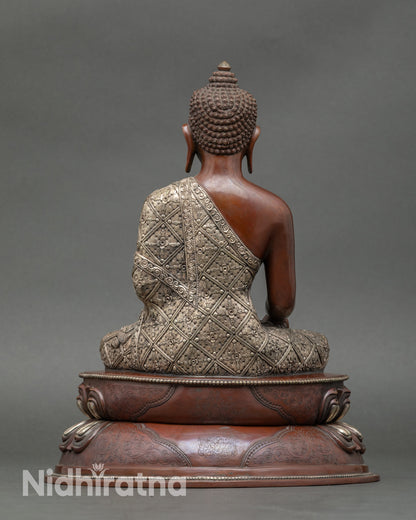 Back view of Nepalese Buddha statue showing detailed robes and lotus pedestal