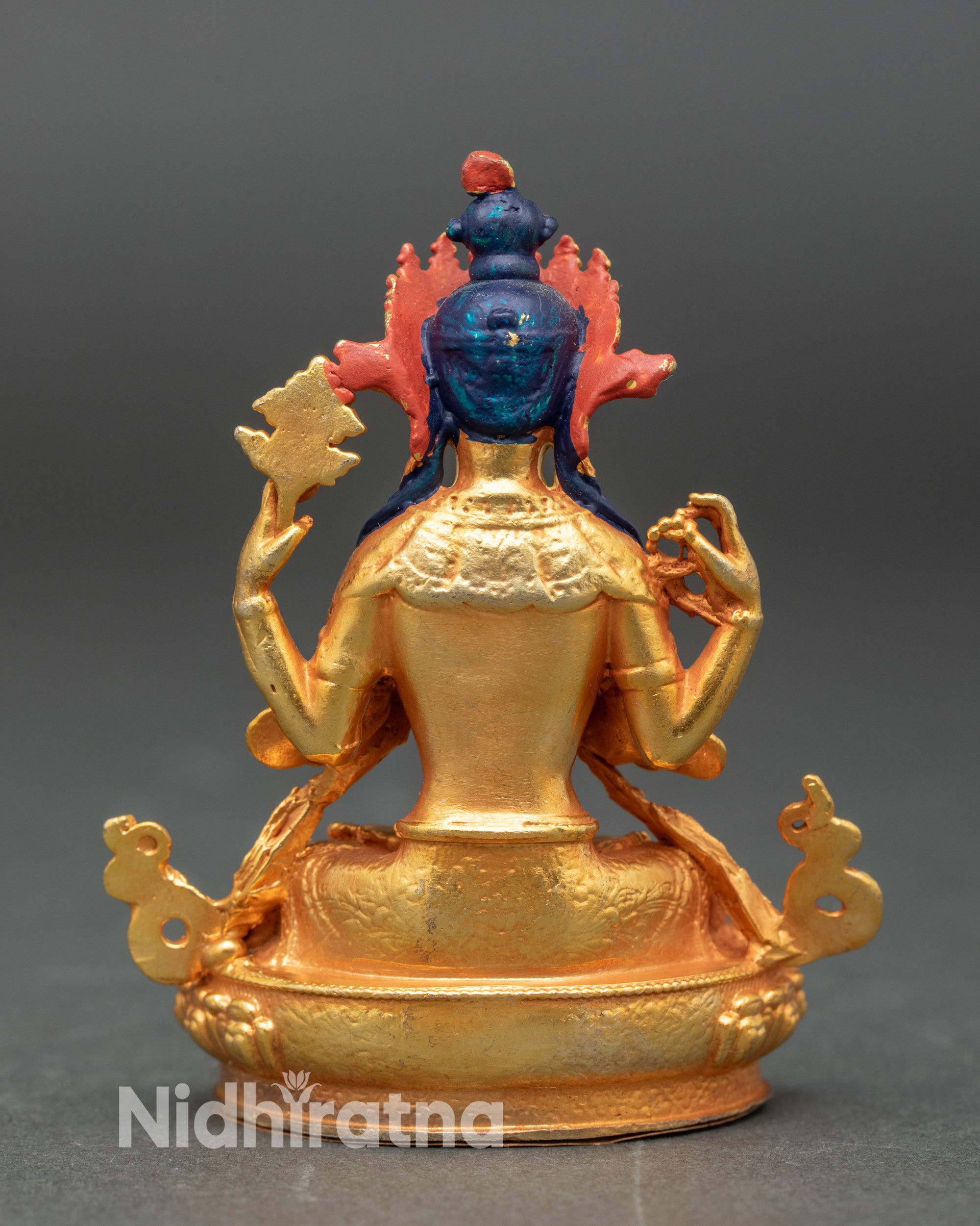 Back view of Nepalese Chenrezig statue, intricate detailing on robes and lotus base