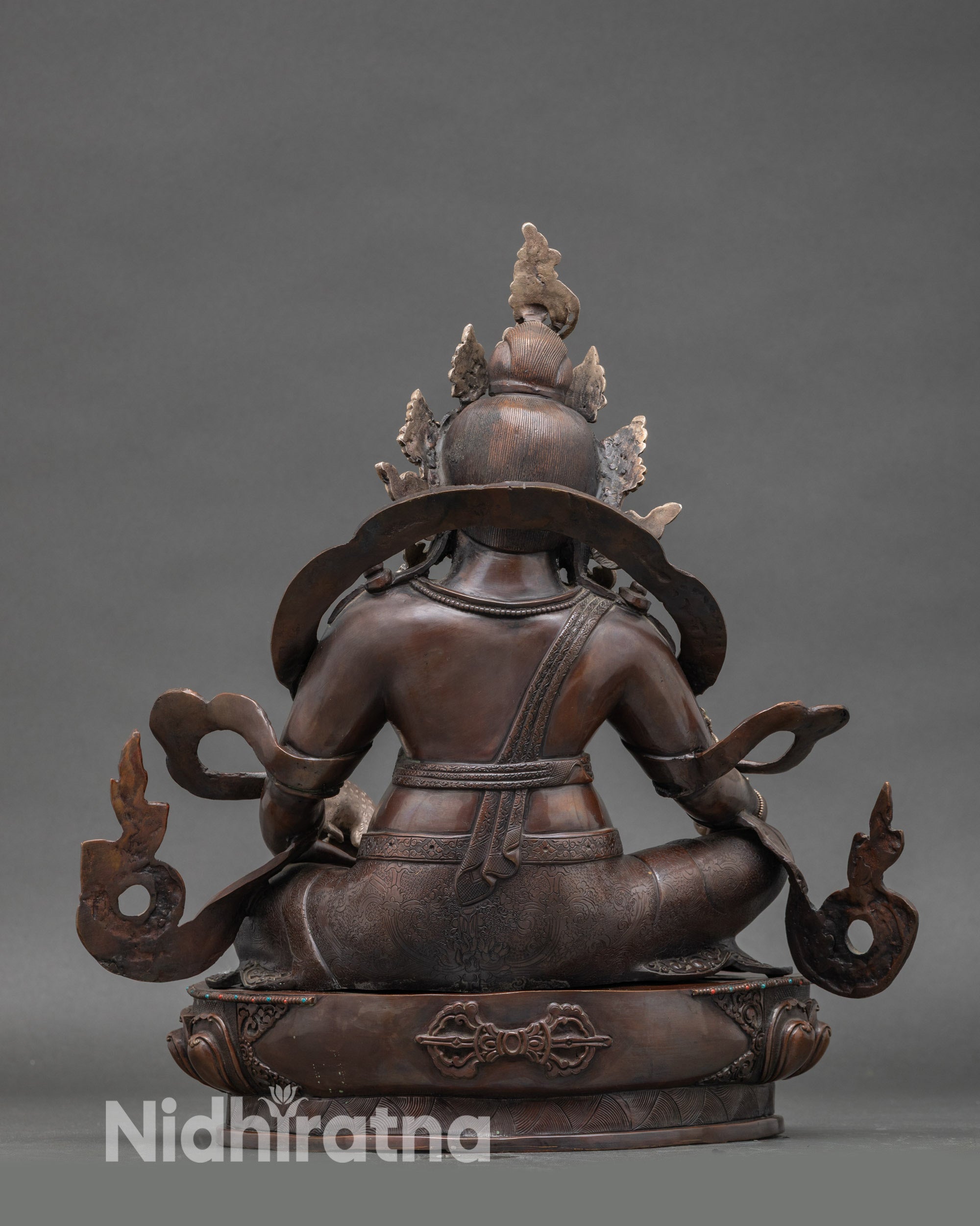 Back view of Nepalese Dzambhala statue on lotus base, traditional lost-wax casting craftsmanship