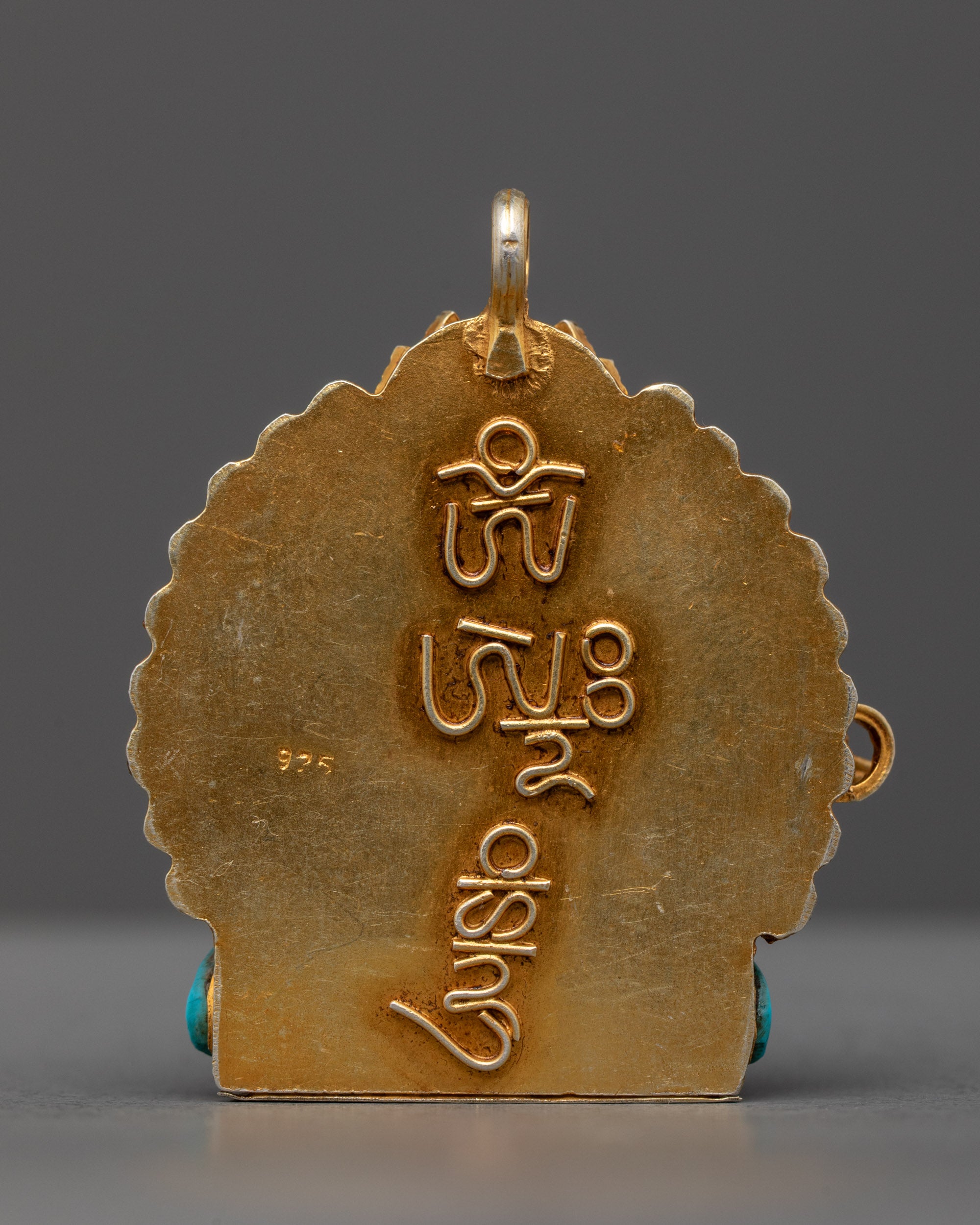 Back view of Nepalese Green Tara locket highlighting hand-carved design and stone inlays