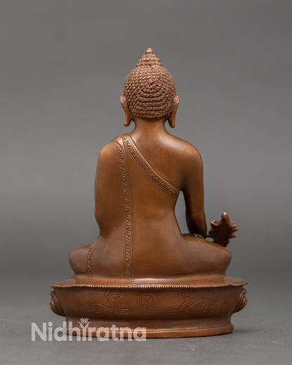 Back view of Nepalese Medicine Buddha statue, intricate lotus throne and oxidized patina