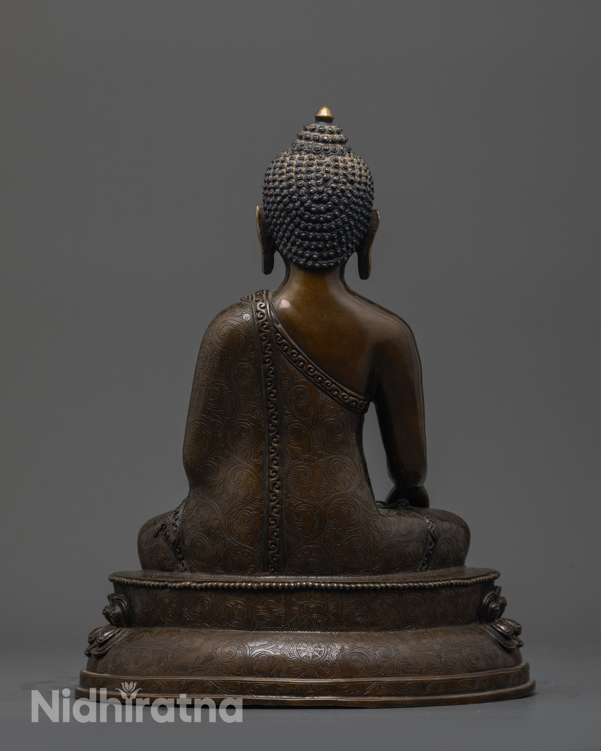 Back view of Oxidized Gautama Buddha Statue showing robe patterns and earthy hue finish