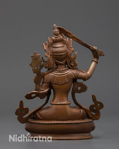 Back view of Oxidized Manjushri Sculpture highlighting detailed robes and lotus base