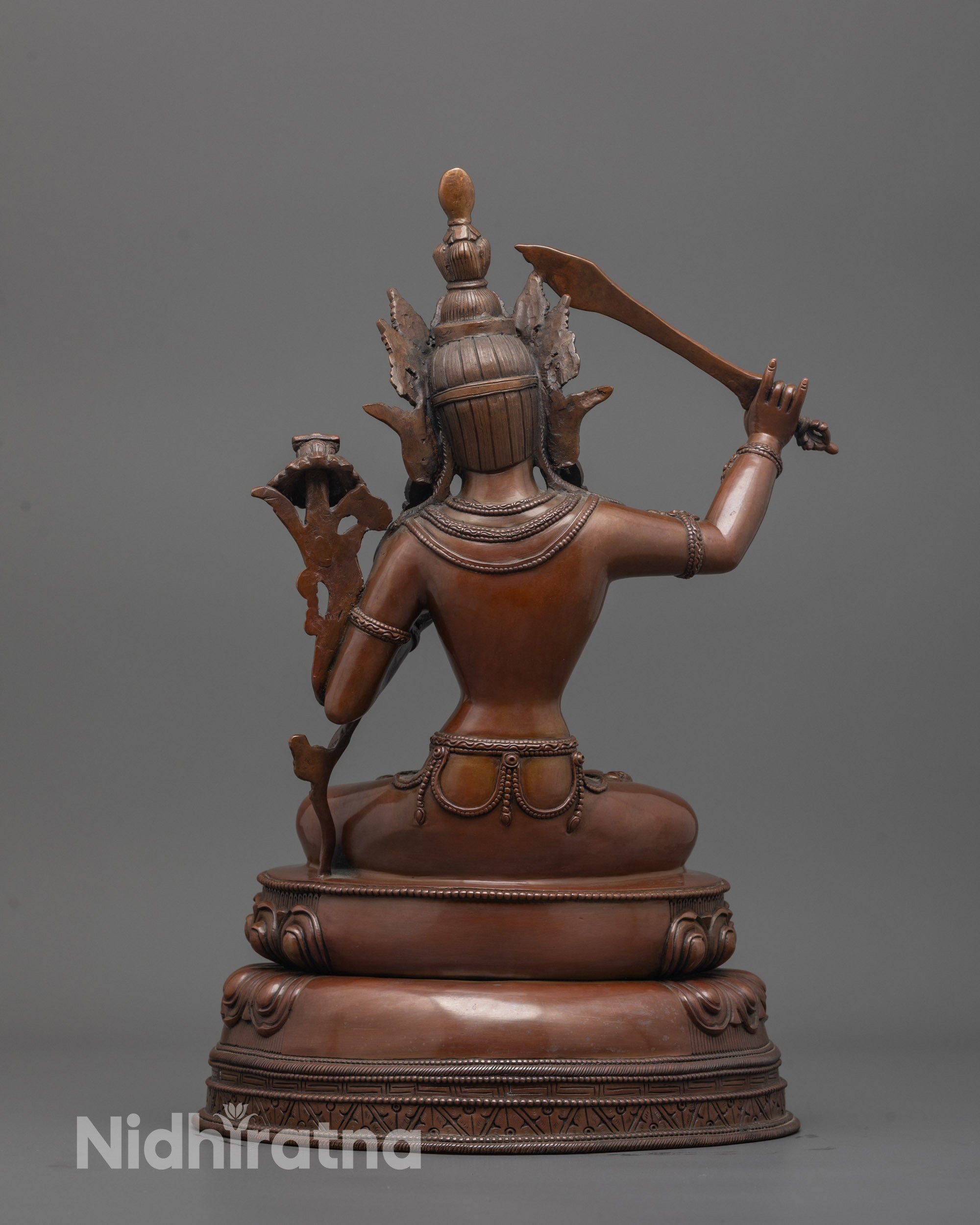 Back view of Oxidized Manjushri Statue highlighting detailed robe and lotus petals