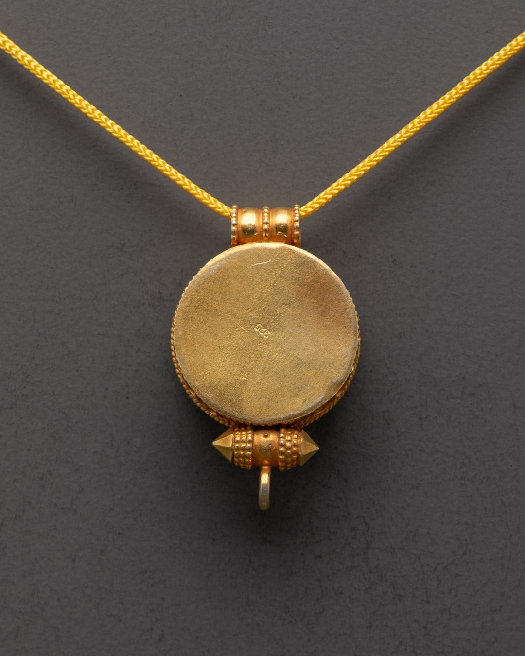 Back view of Parasol Locket showing detailed patterns and gold-gilded craftsmanship
