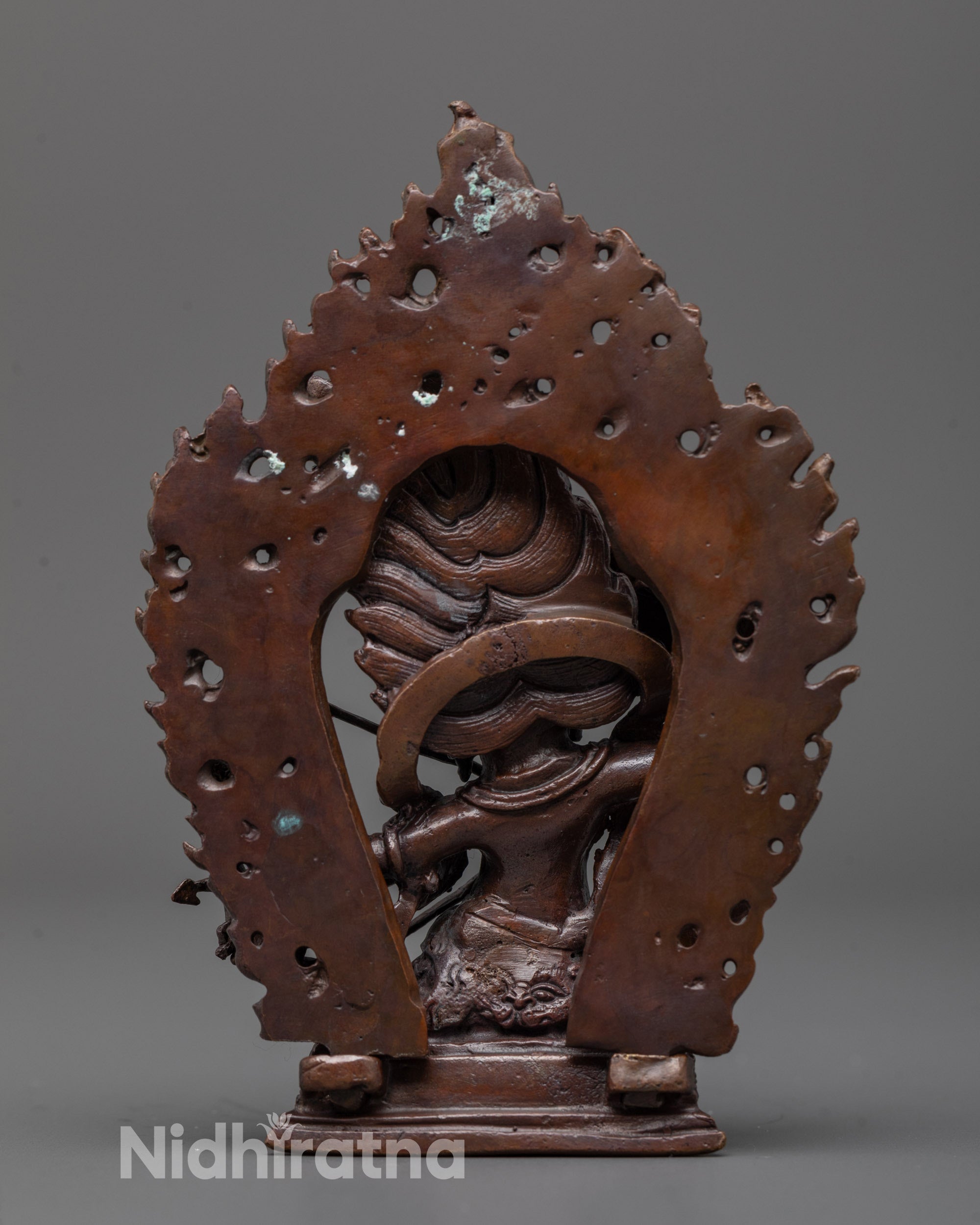 Back view of Rahula Statue with oxidized copper finish and detailed halo design
