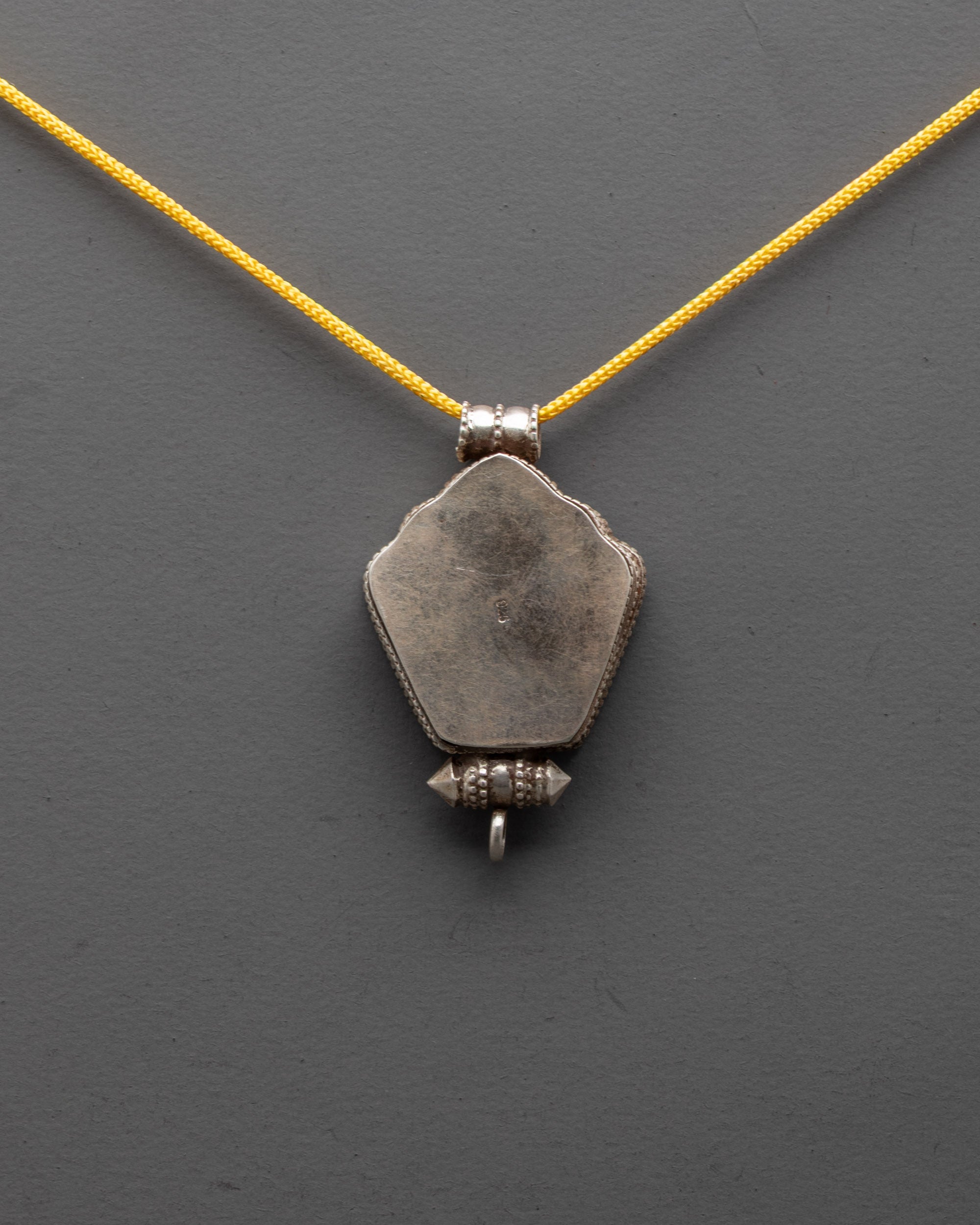 Back view of Sacred Om Locket highlighting artisan-carved copper craftsmanship
