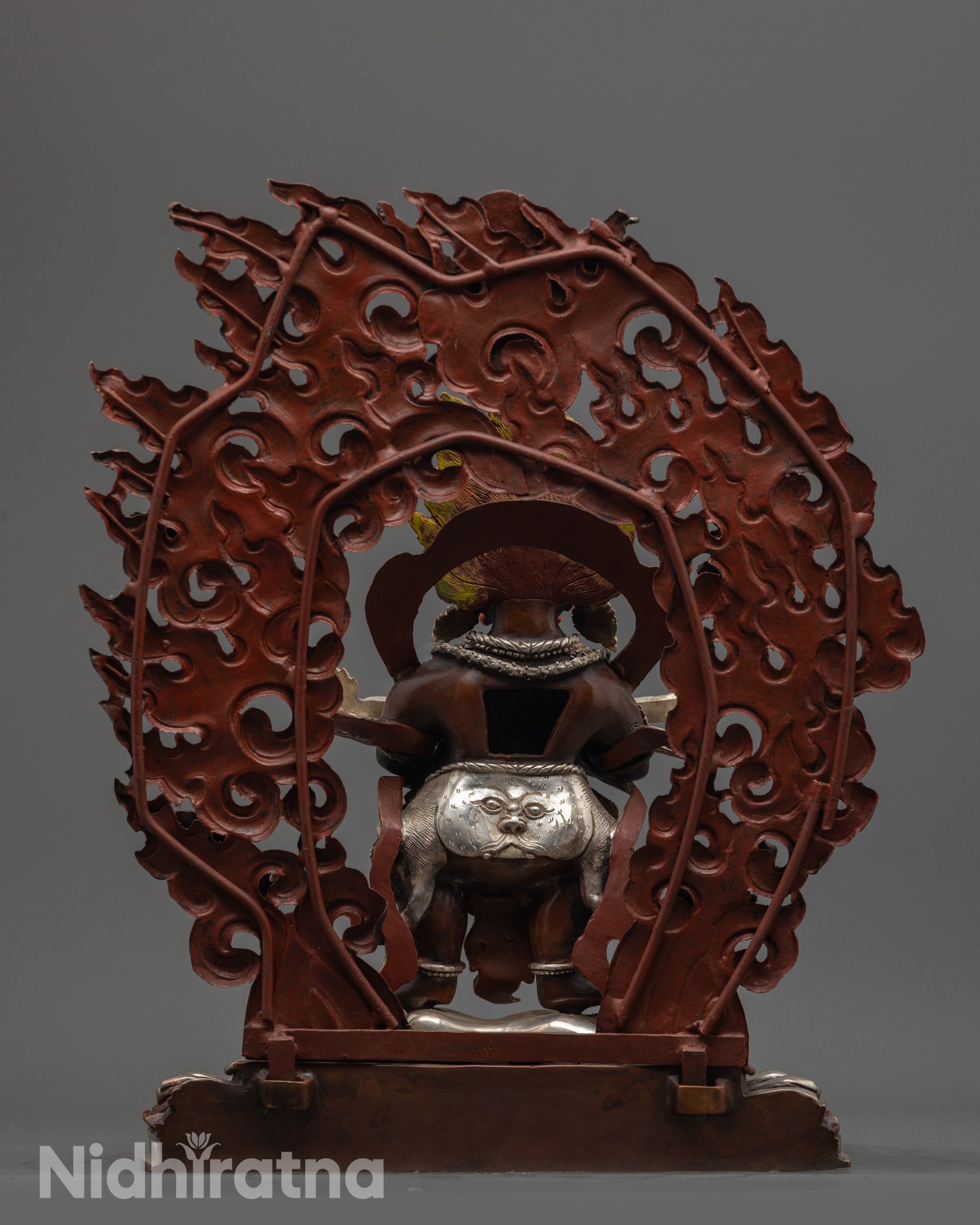 Back view of Sakya Mahakala statue featuring miniature Garuda and carved halo in silver finish