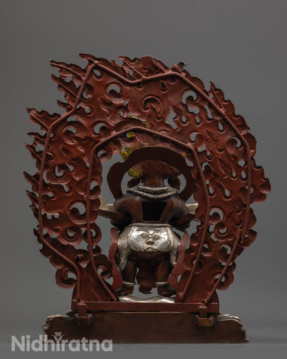 Back view of Sakya Mahakala statue featuring miniature Garuda and carved halo in silver finish