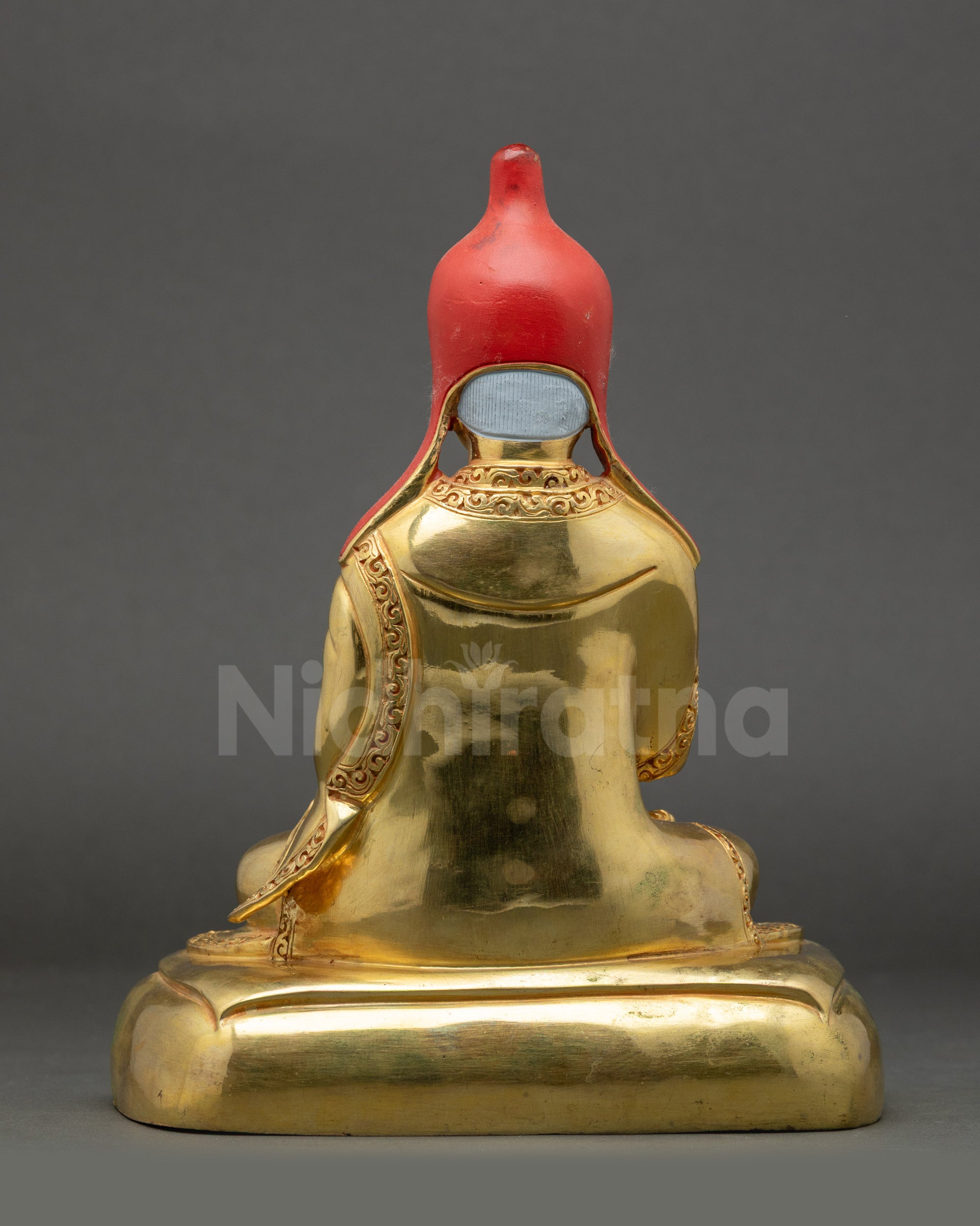 Back view of Santarakshita Statue showing flowing garments and ornaments