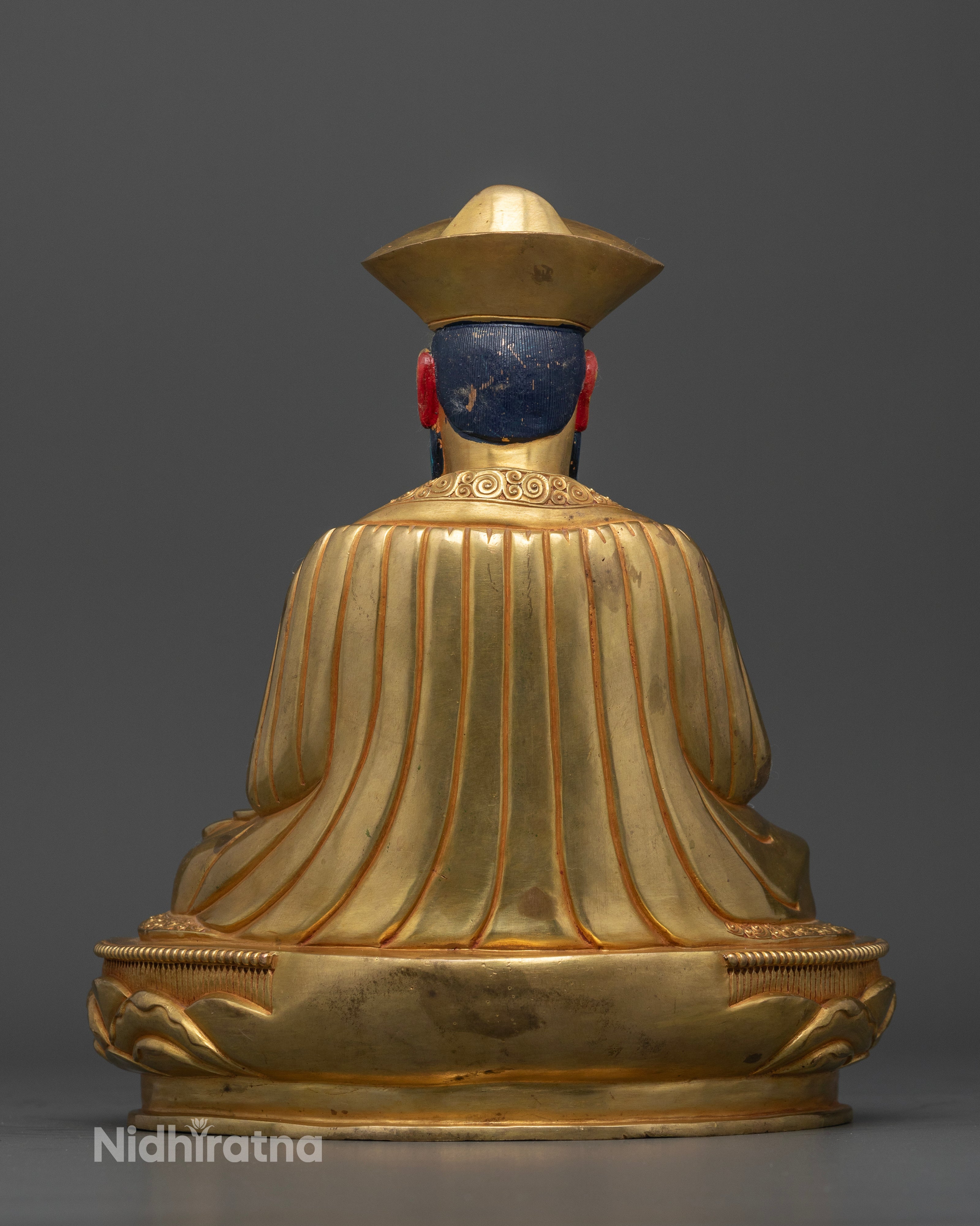Back view of Shabdrung Ngawang Namgyal statue with hollow chamber and decorative lotus base