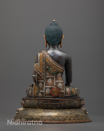 Back view of Shakyamuni Buddha Sculpture showing detailed robe design and antique oxidized finish
