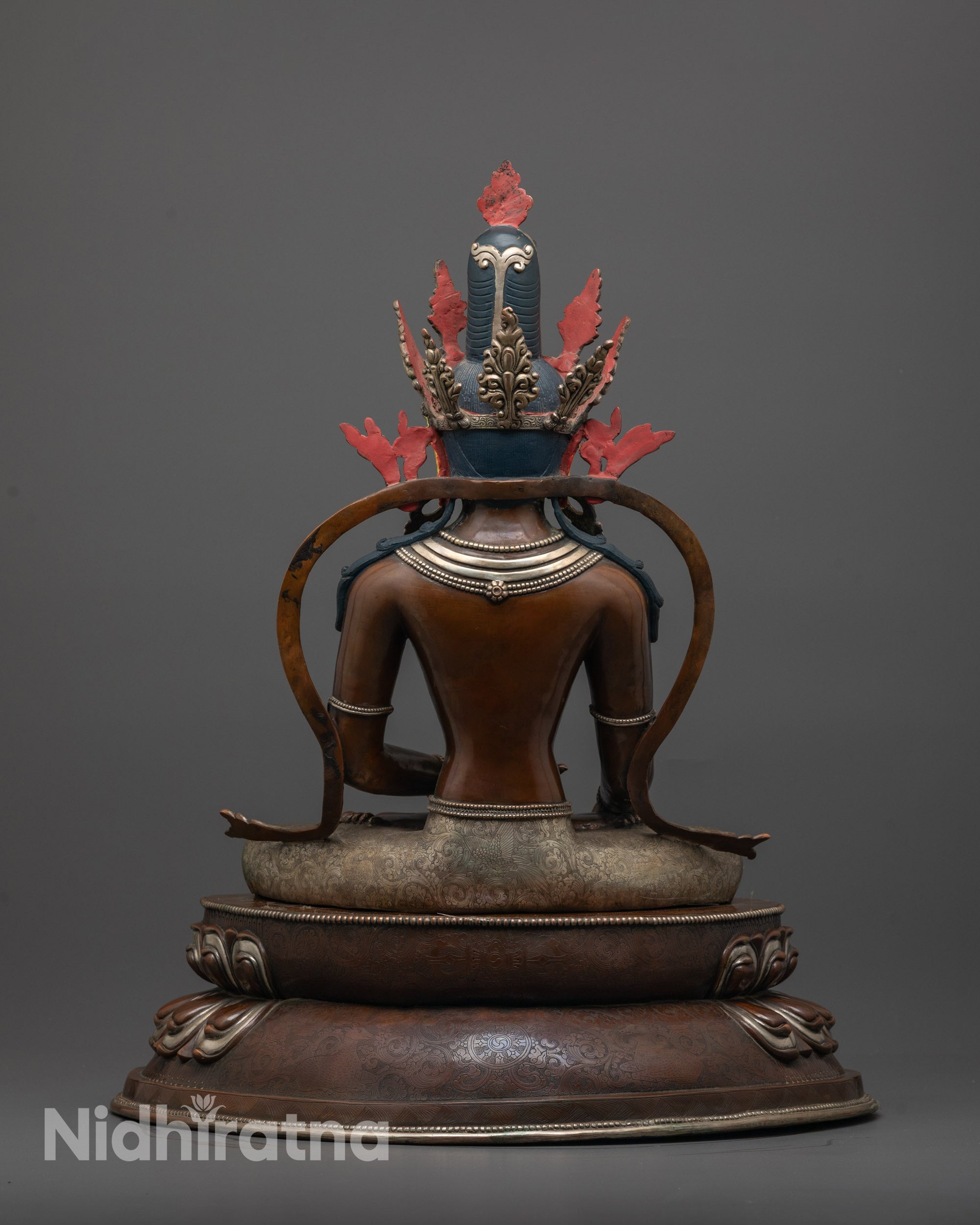 Back view of Shakyamuni Buddha Statue with detailed robe and oxidized copper finish