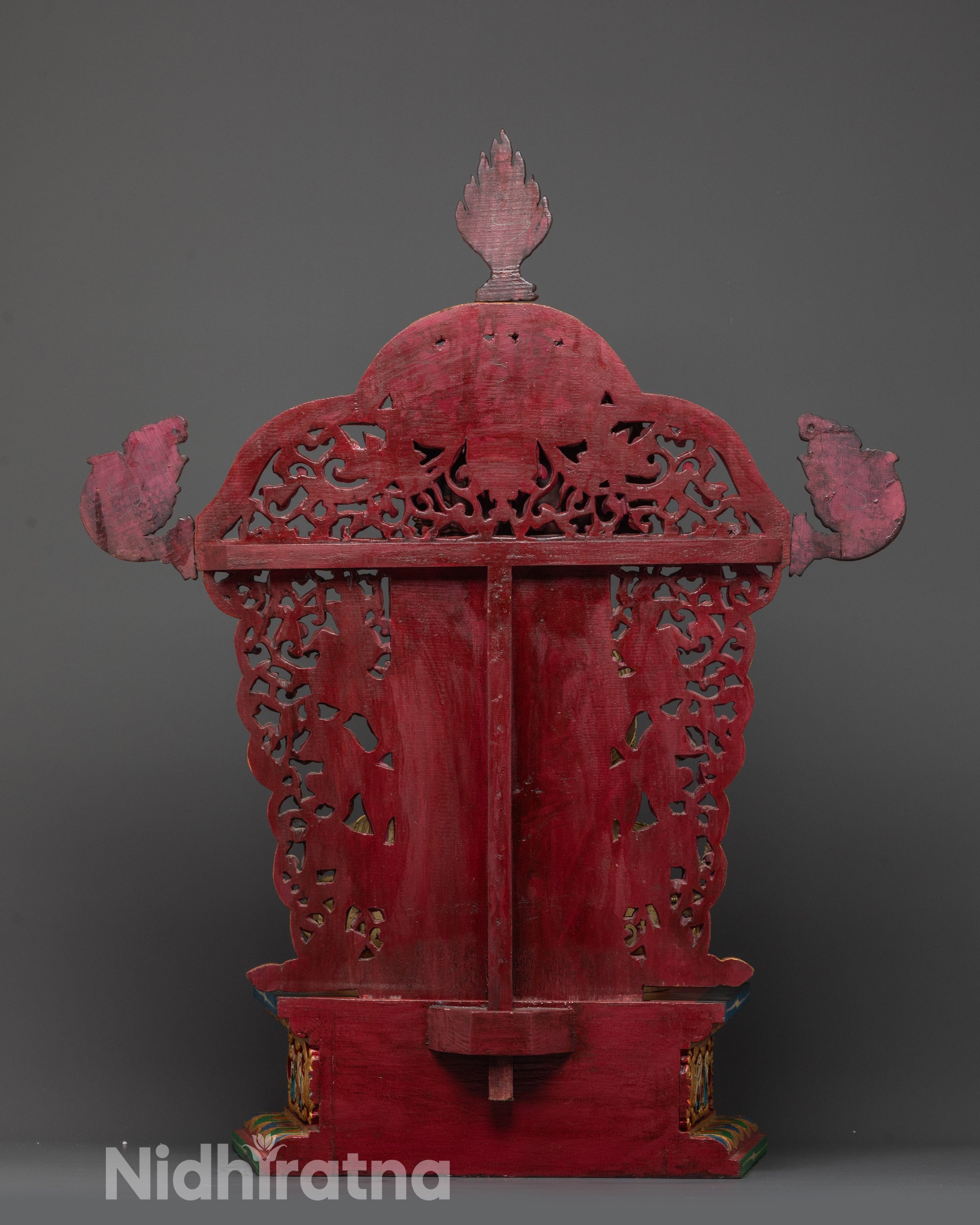 Back view of Shakyamuni Buddha showing halo, miniature deities, and carved lion throne