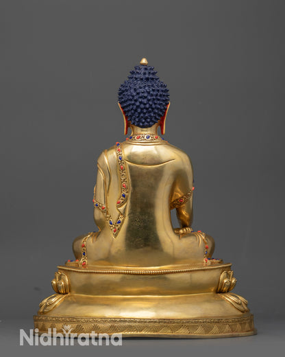 Back view of Shakyamuni Buddha statue highlighting carved robe patterns and lotus base 