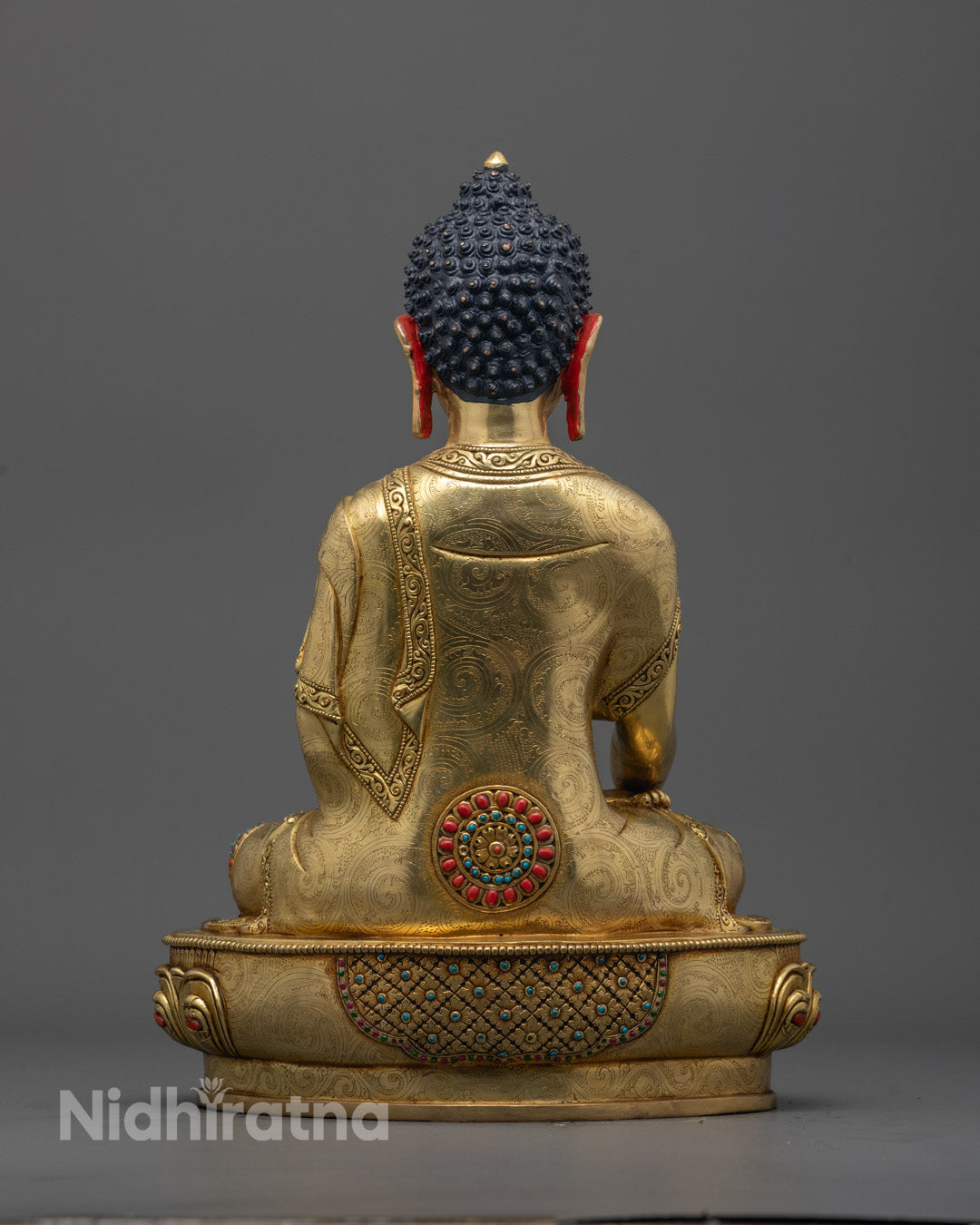Back view of Shakyamuni Buddha statue highlighting gold fire-gilded body and patterns


