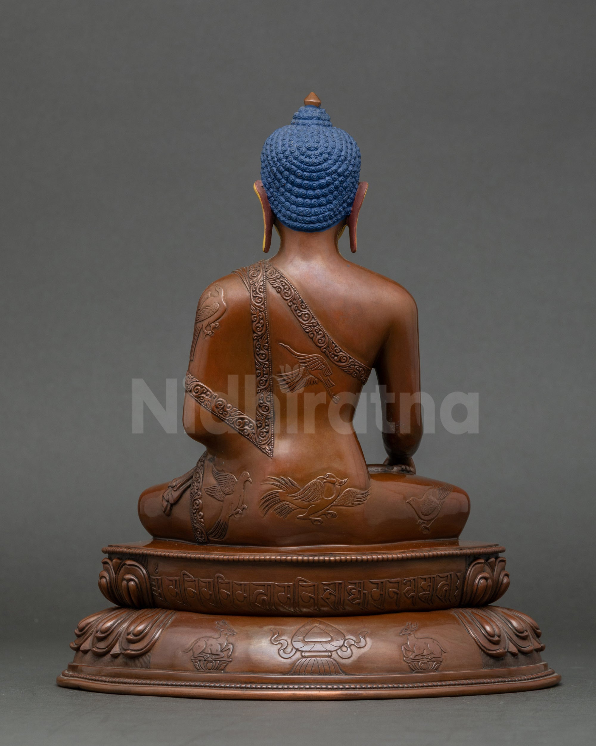 Back view of Shakyamuni Buddha statue on double lotus throne with intricate details