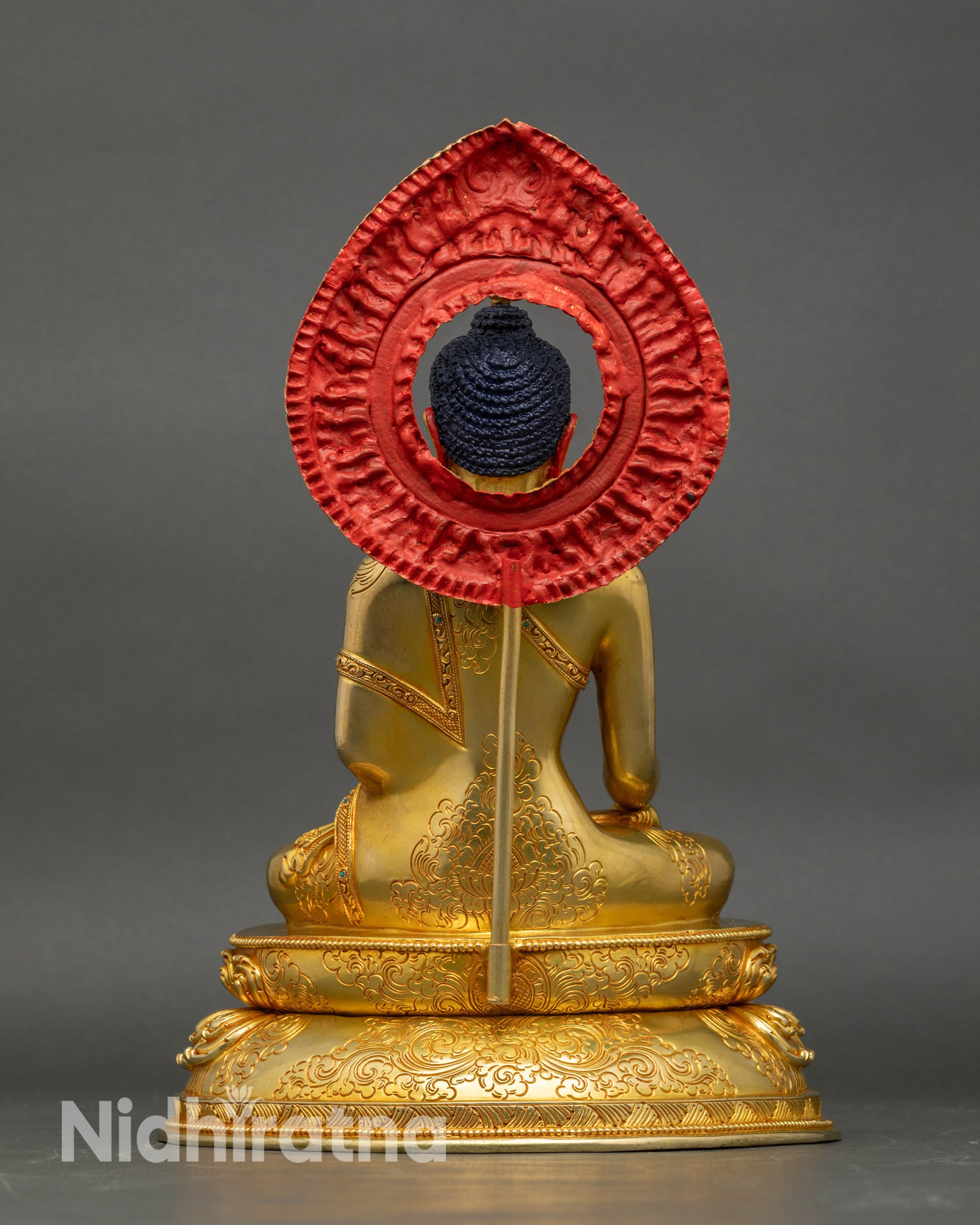 Back view of Shakyamuni Buddha statue, showing copper craftsmanship and divine halo