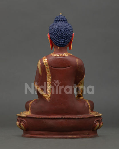 Back view of Shakyamuni Buddha statue showing engraved detailing, copper craftsmanship, and gilded finish