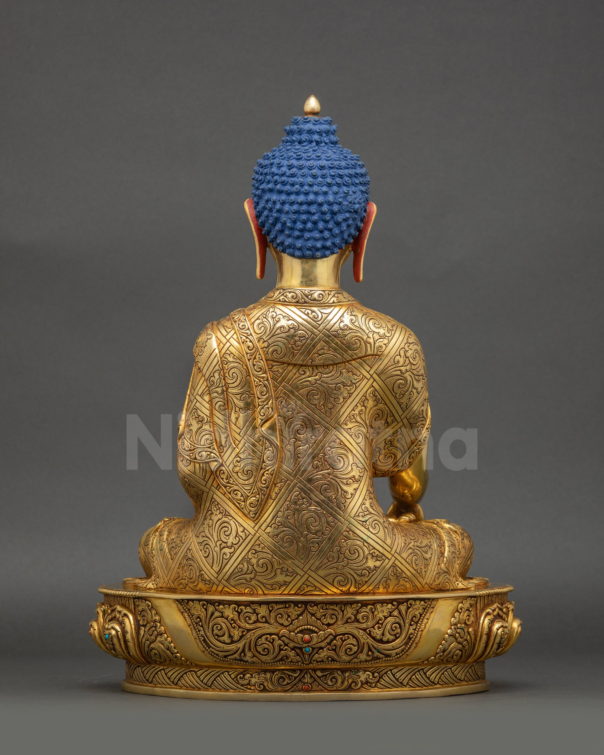 Back view of Shakyamuni Buddha statue showing intricate robe patterns