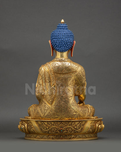 Back view of Shakyamuni Buddha statue showing intricate robe patterns