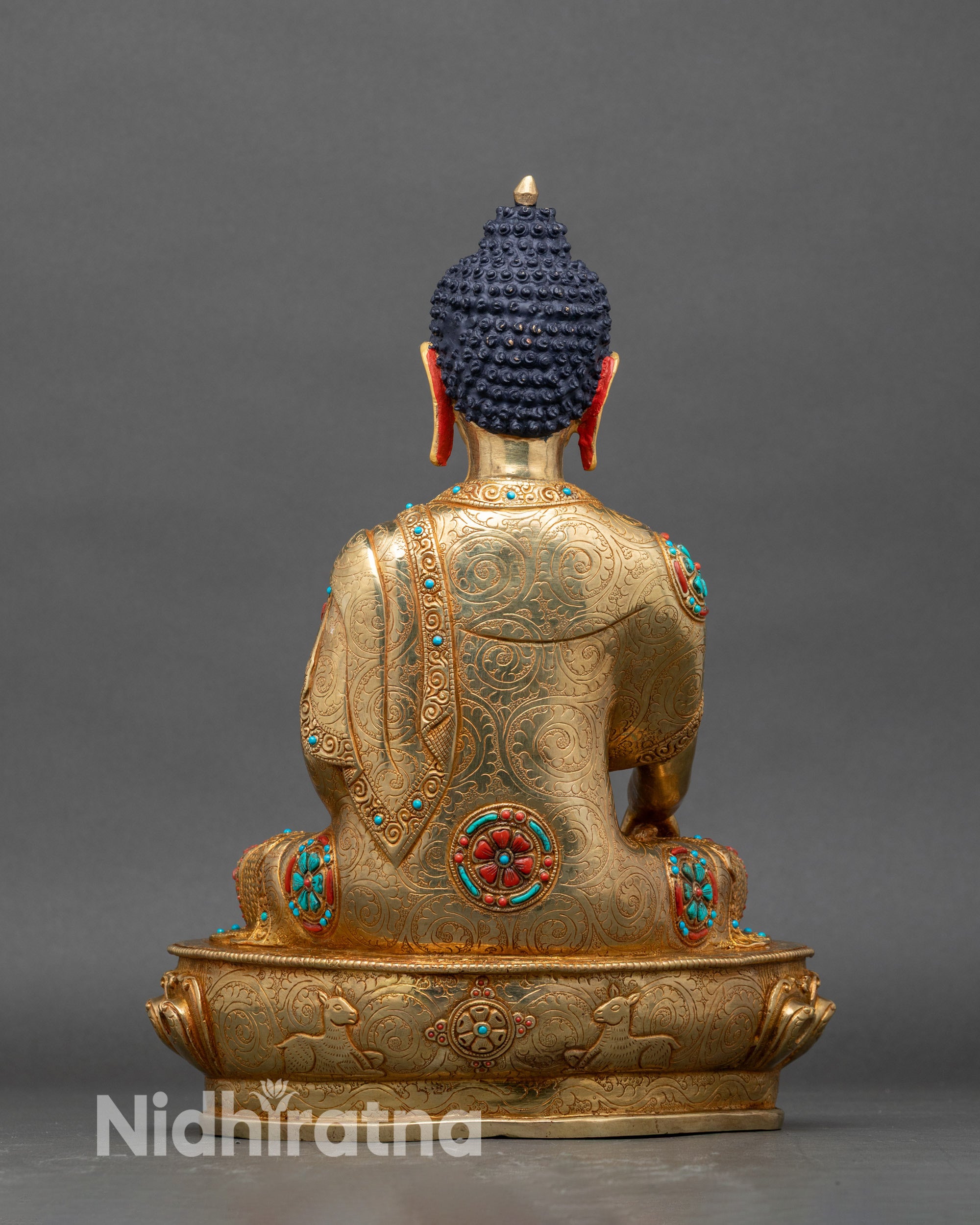 Back view of Shakyamuni Buddha statue with detailed robe engraving and gilded copper finish
