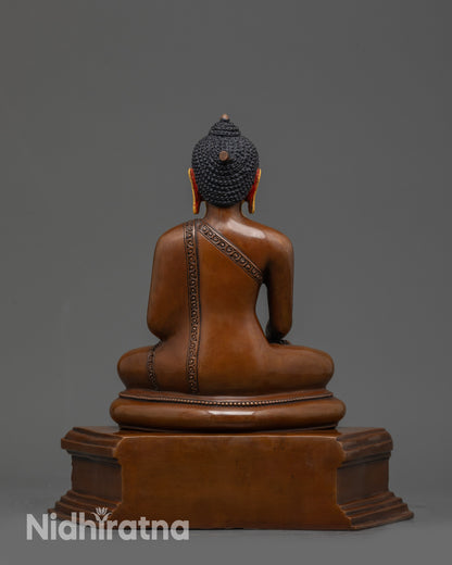 Back view of Tibetan Buddhist Shakyamuni Buddha statue showing oxidized copper details