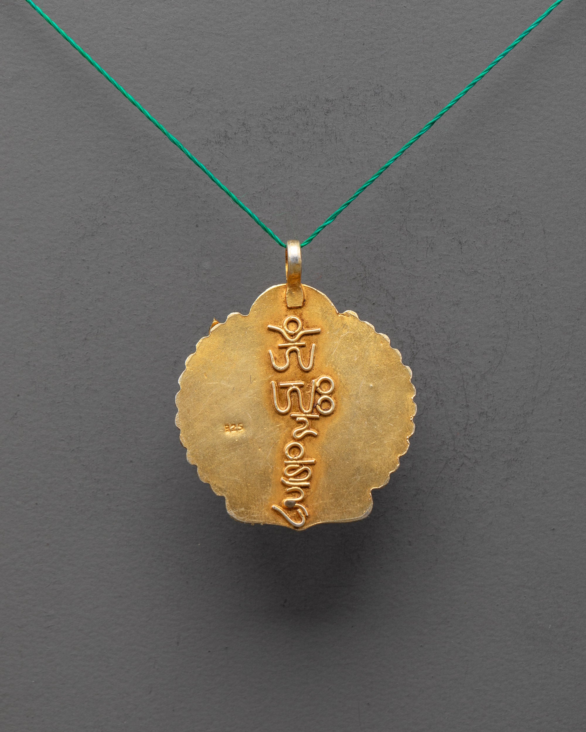 Back view of Tibetan Chenrezig Locket, showcasing fine craftsmanship and ornamental carvings on the gold-gilded surface.