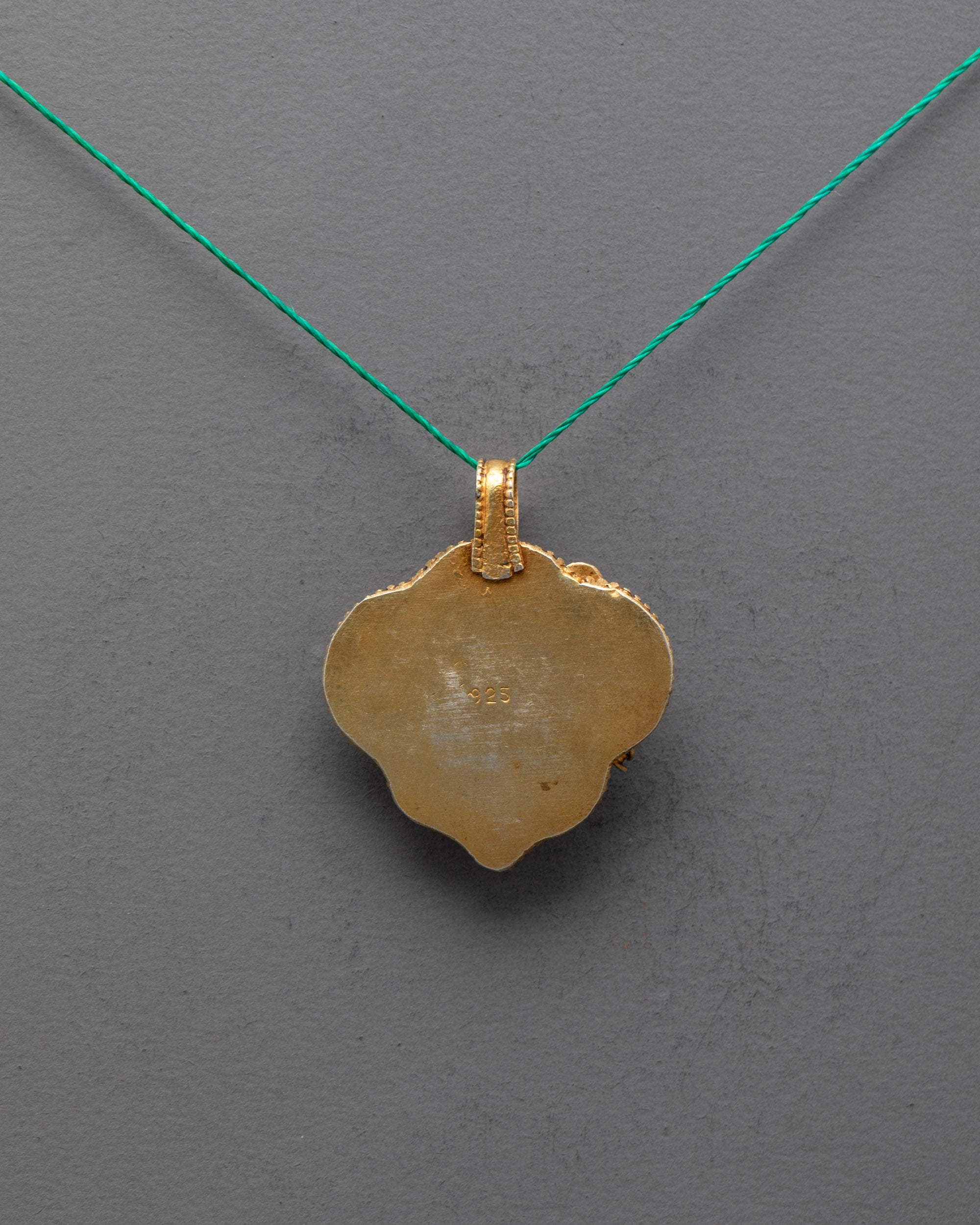 Back view of Tibetan Green Tara Locket, showcasing fine handcrafted carvings and traditional Himalayan metalwork craftsmanship.
