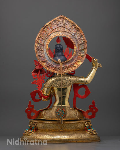 Back view of Tibetan Manjushri statue highlighting detailed carvings and lotus throne