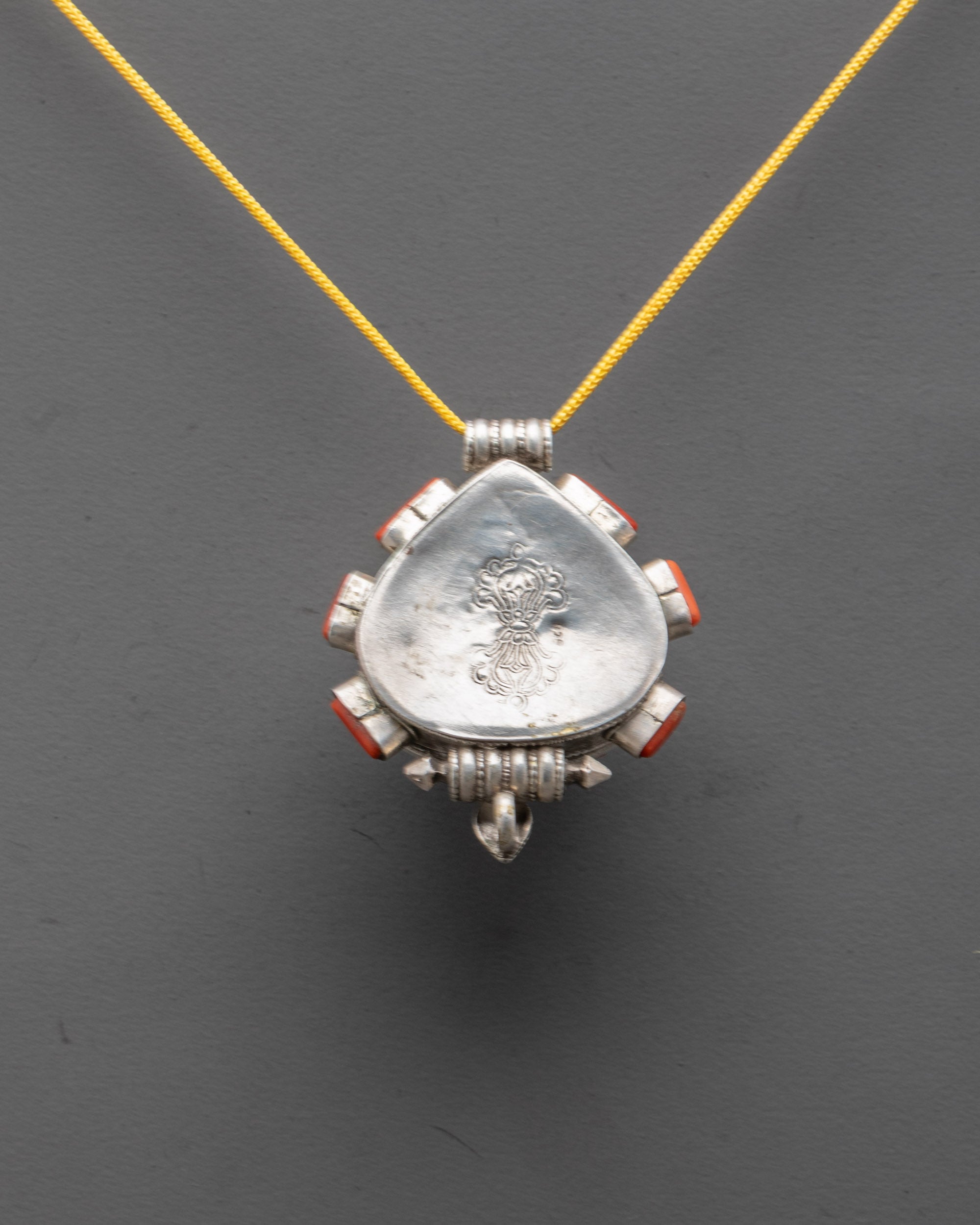 Back view of Traditional Coral Locket displaying ornate filigree and artisan carving details
