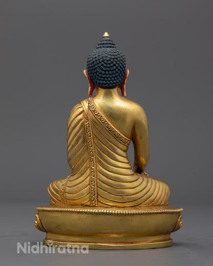 Back view of Traditional Nepalese artisan handcrafting a Shakyamuni Buddha sculpture