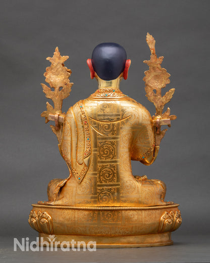 Back view of Tsongkhapa, showing engraved lotus base and detailed robe folds