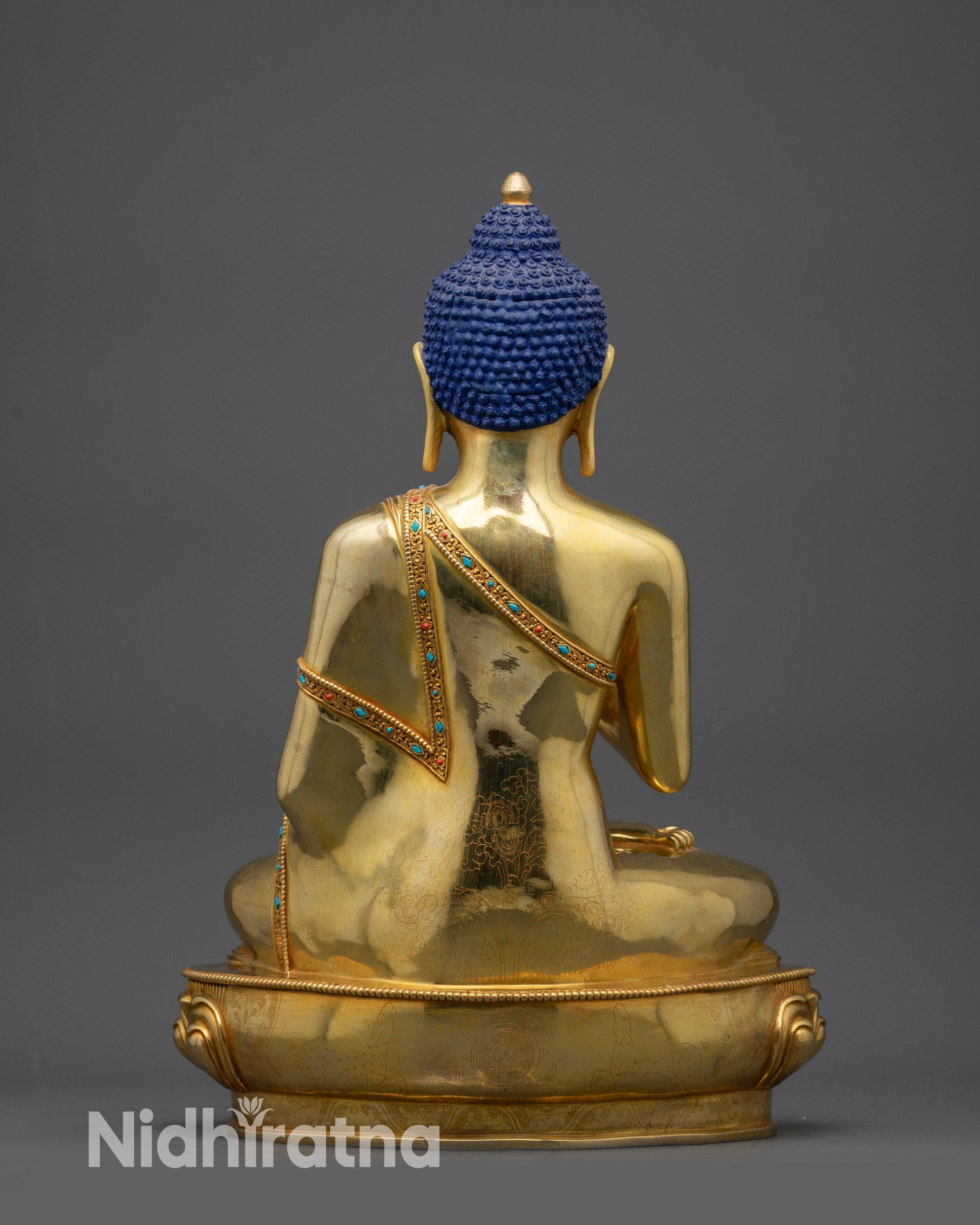 Back view of Vairocana Buddha statue showing draped monk’s robe