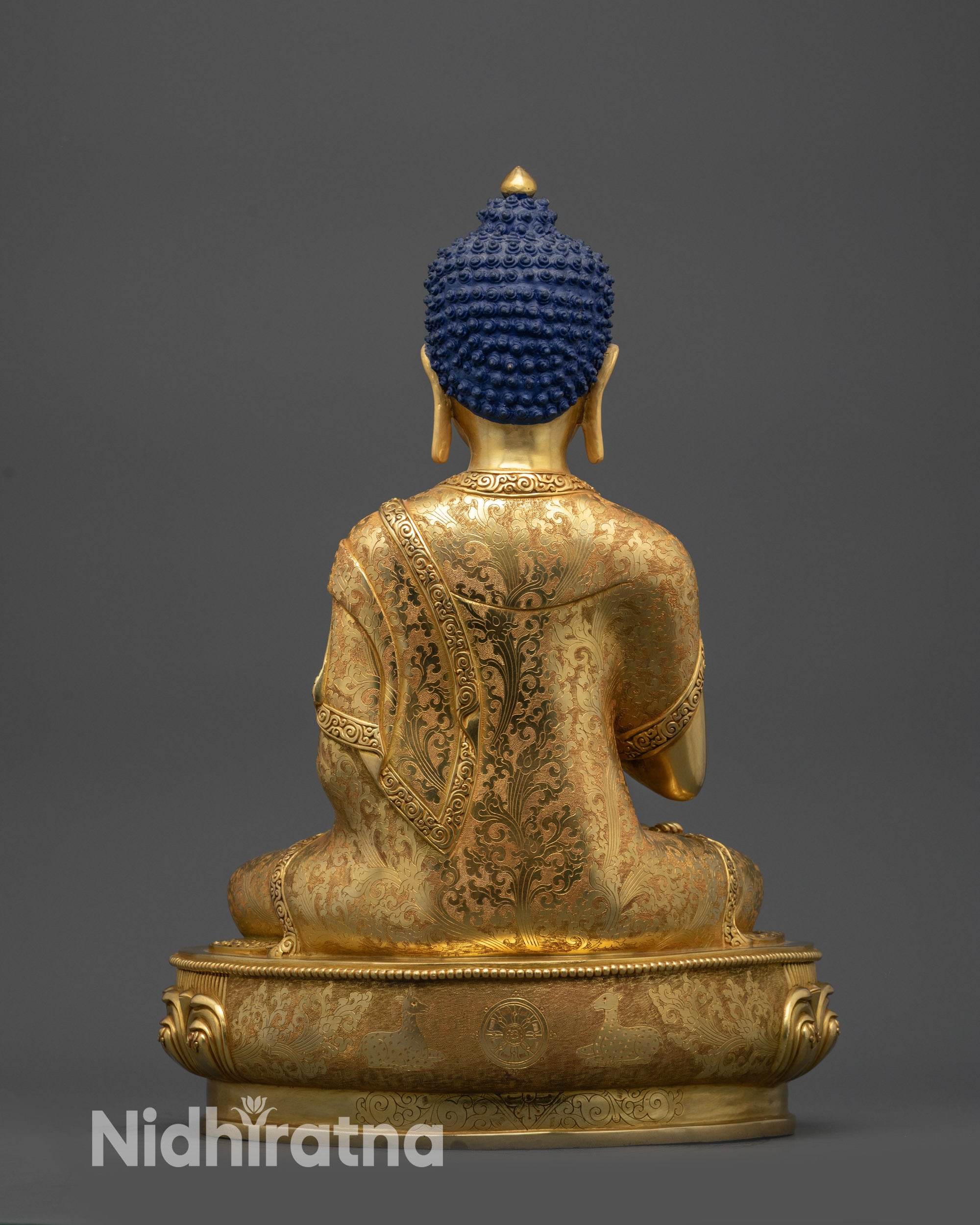 Back view of Vairocana Buddha statue showing intricate robe details and lotus seat