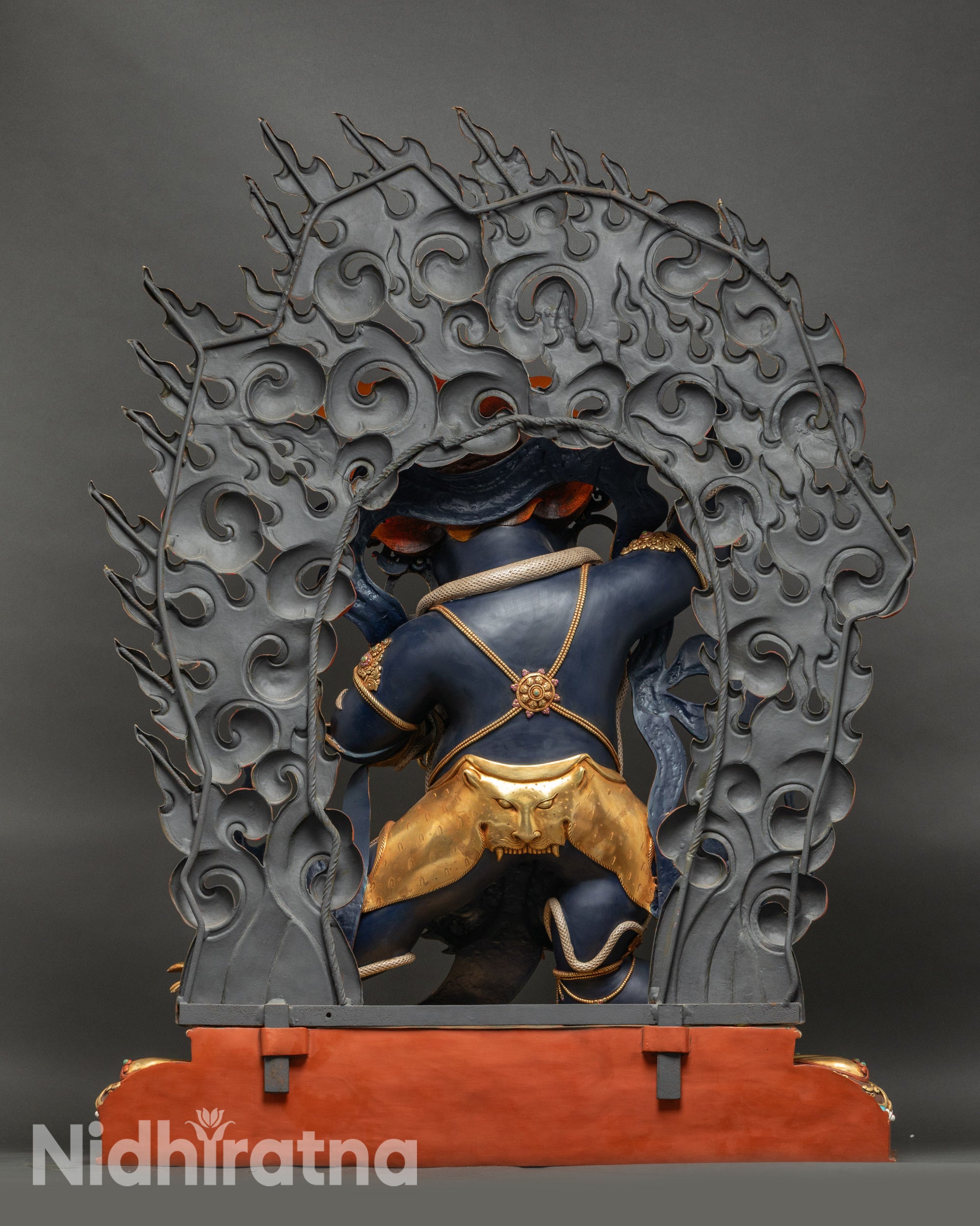 Back view of Vajrapani statue, gold-fire-gilded robe and ornate lotus seat