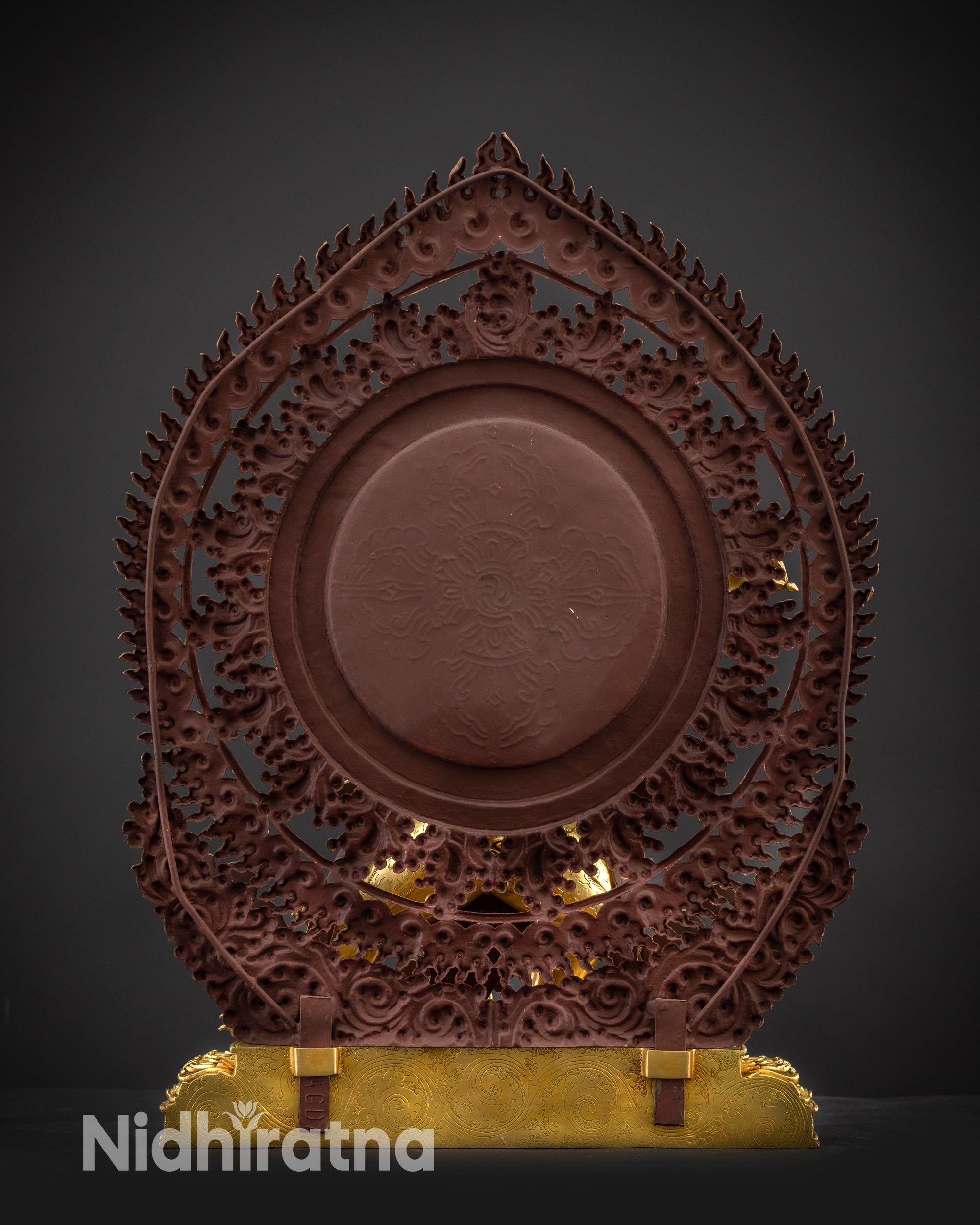 Back view of Vajrapani statue with halo and lotus seat carvings
