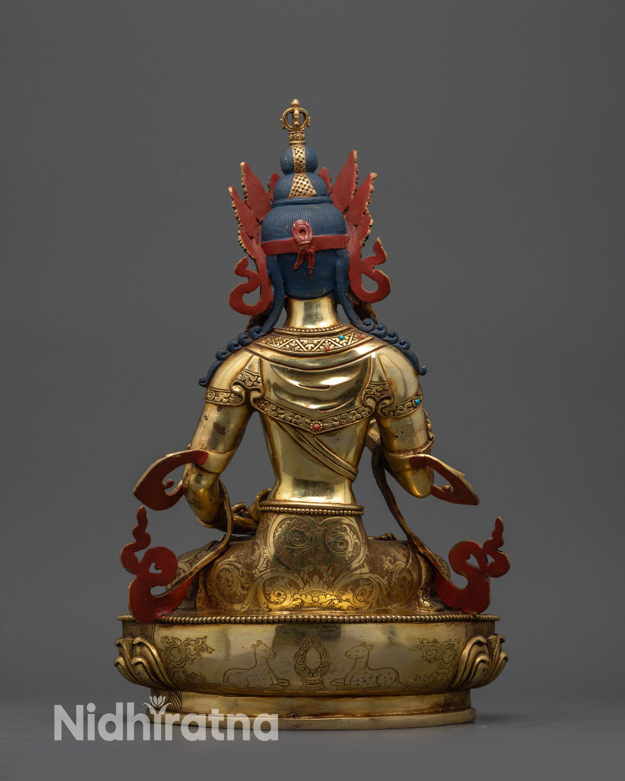 Back view of Vajrasattva Statue showing dharmachakra, deer carvings, and lotus seat jewelry
