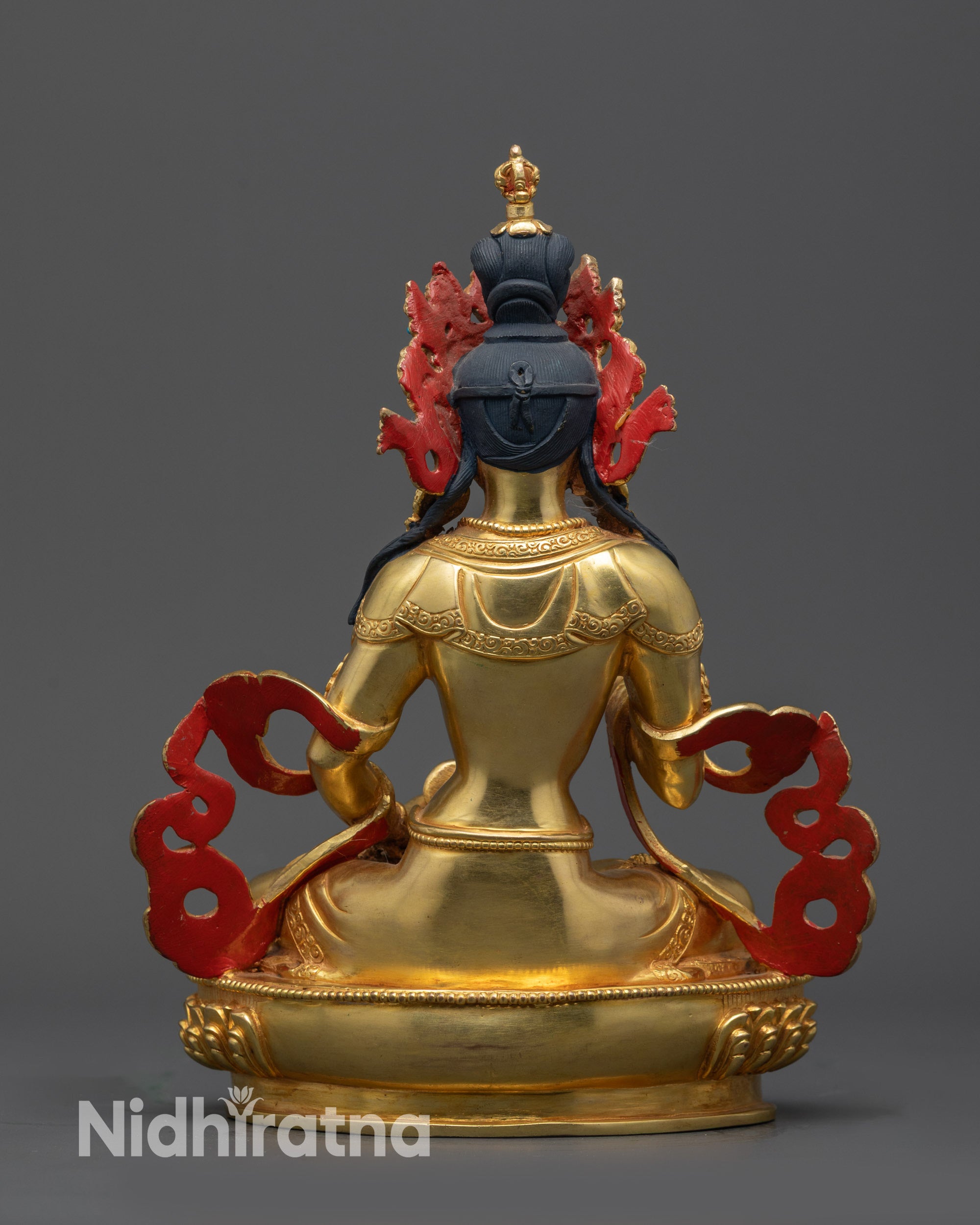Back view of Vajrasattva altar sculpture showing carved robe and semi-precious stones