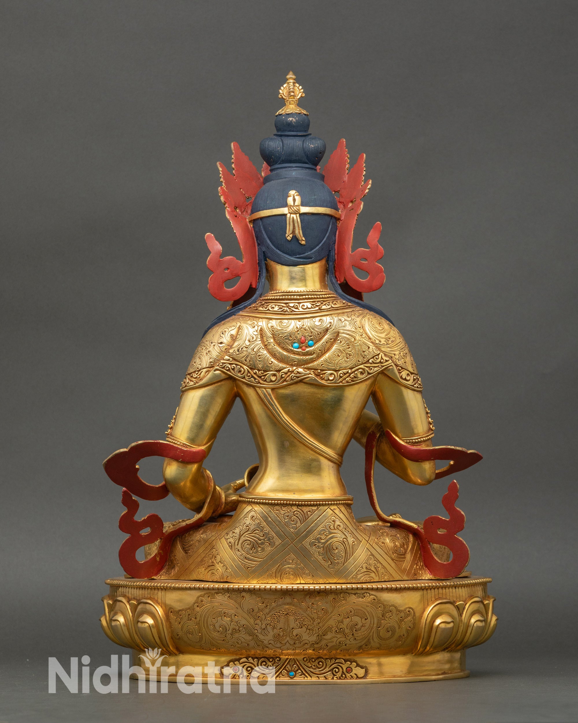 Back view of Vajrasattva sculpture showing detailed carving and gilded copper finish