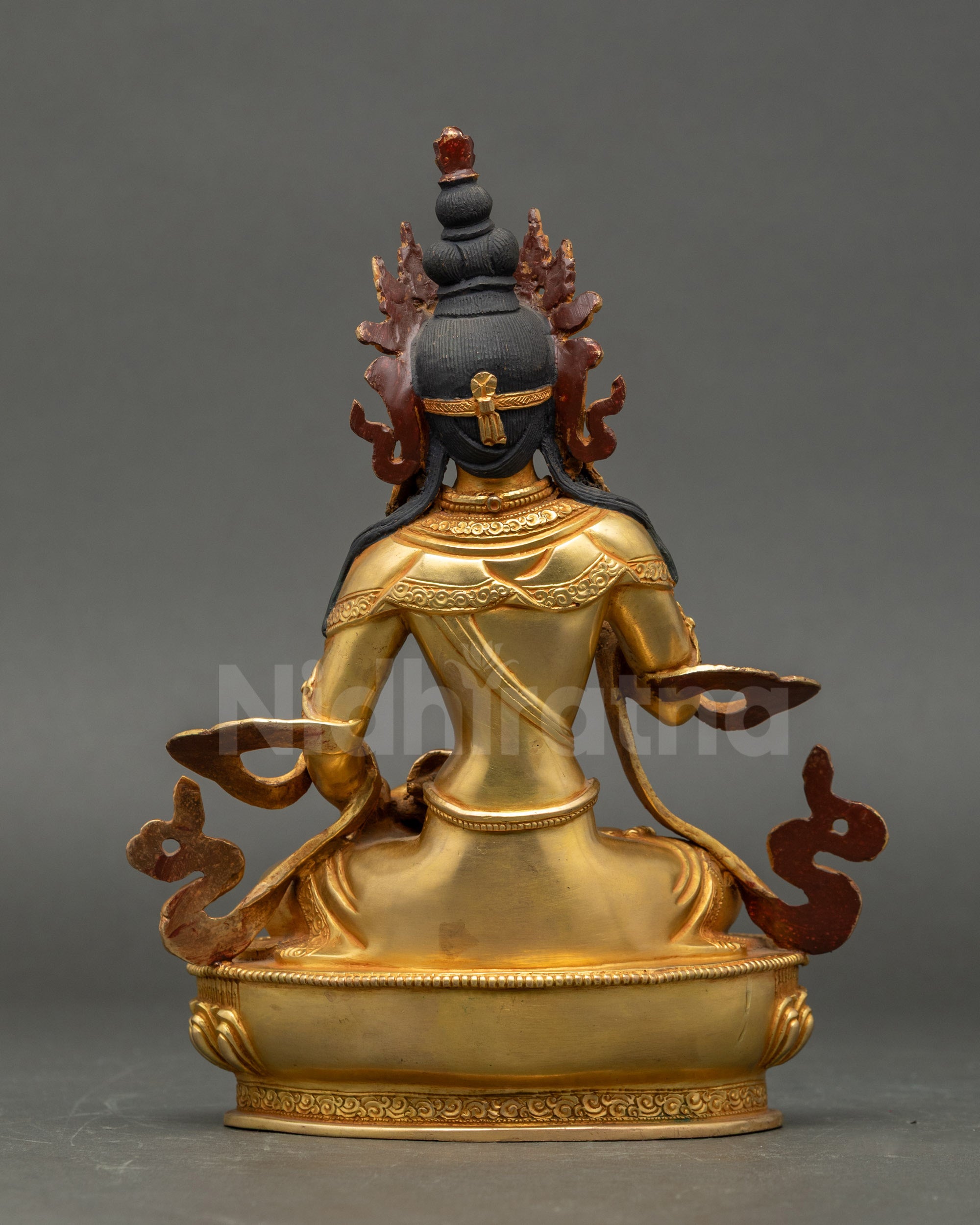 Back view of Vajrasattva statue, intricate lotus base and Nepalese Buddhist ritual design